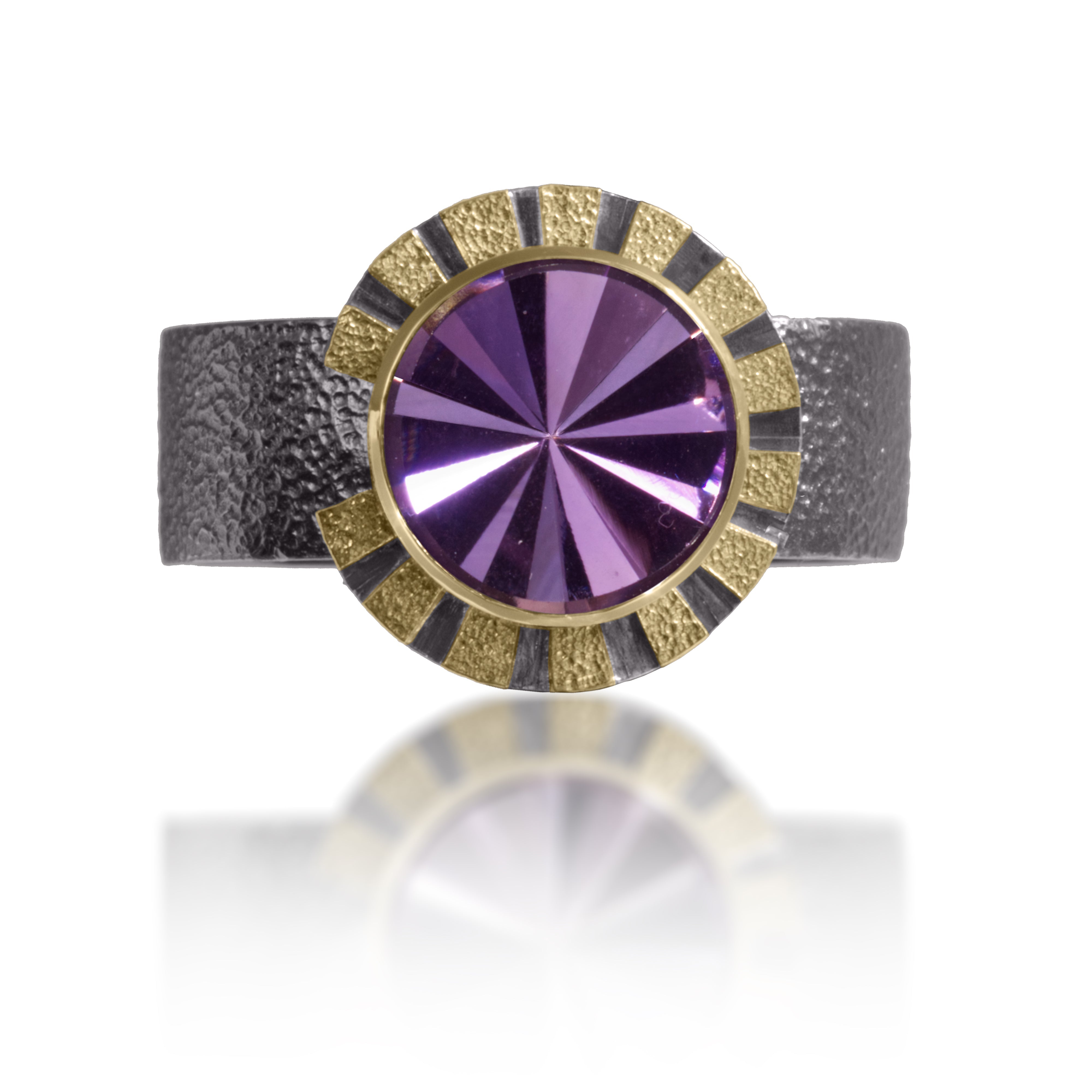 Stripe Ring #1 in 18k gold and oxidized sterling silver with a bezel set radial cut, semiprecious center stone. Hand fabricated, stipple textured and engraved mixed metals. Textured band with rounded “comfort” contour.