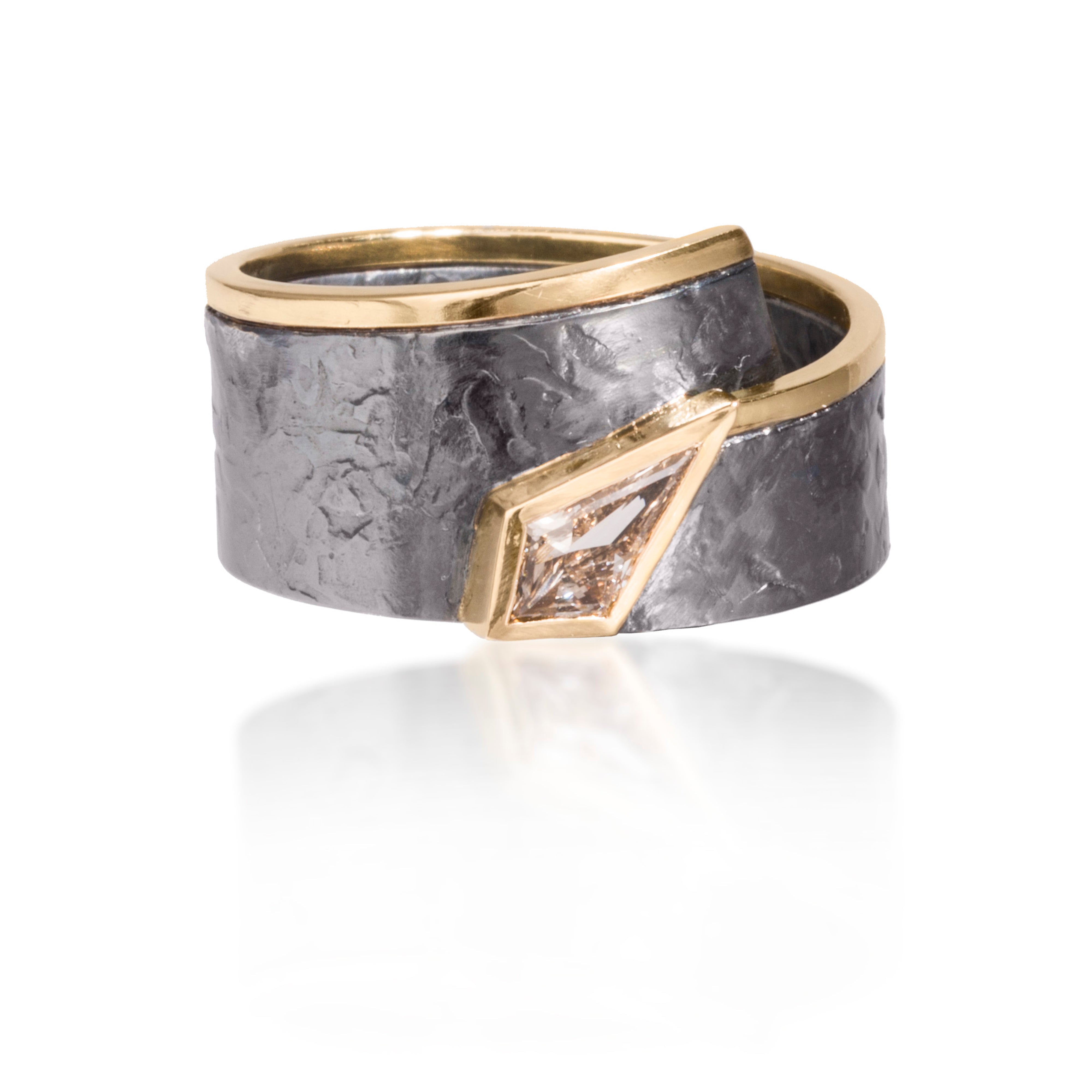 This simple, yet distinctive, one of kind ring in 18k gold and oxidized silver features a bezel set Kite shaped champagne diamond, 0.30 tcw. It is forged, textured and fabricated by hand.
