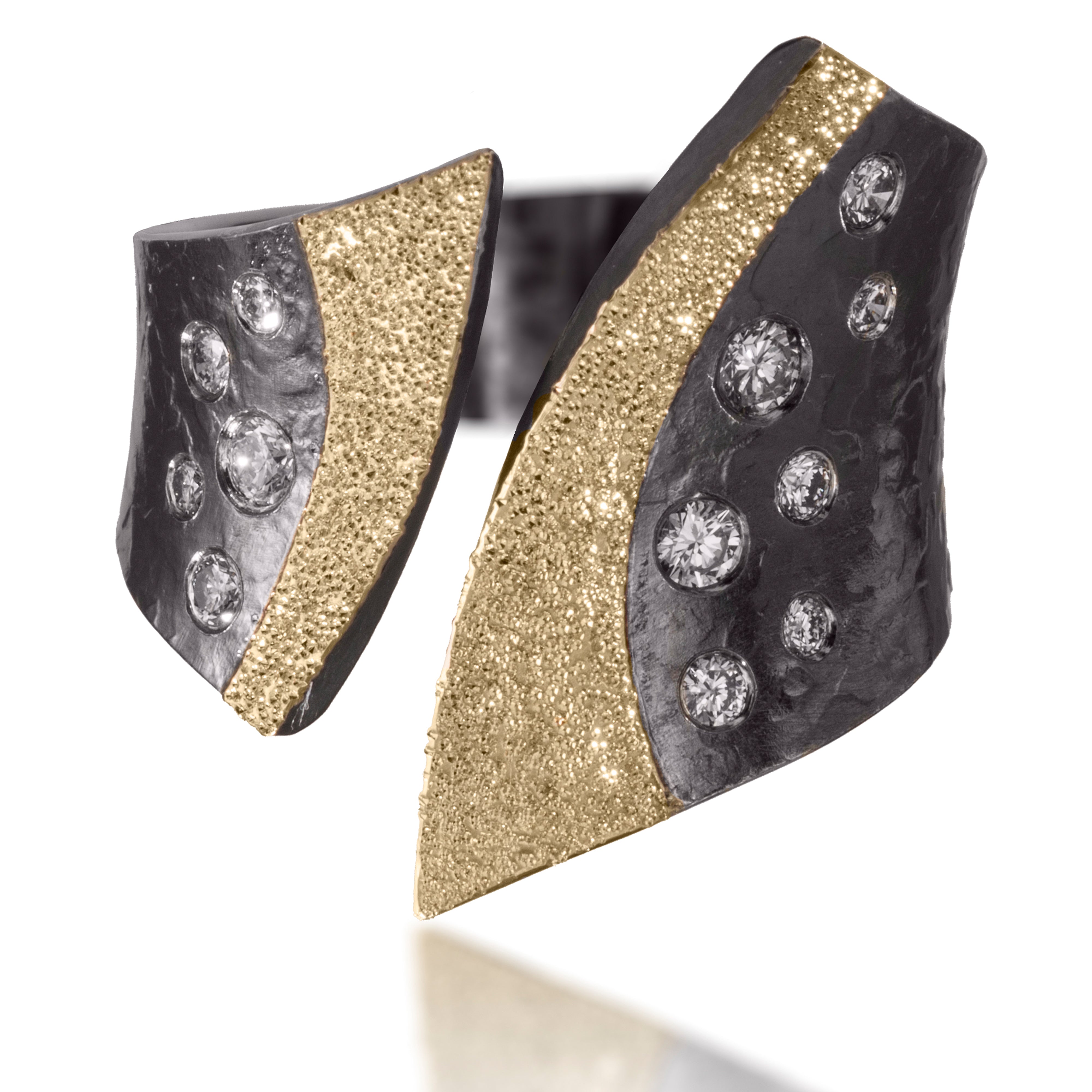 This scintillating variation is nicknamed "tuxedo". Created in 18k gold and oxidized silver, the "tuxedo lapels" are texture with a diamond and framed by flush set assorted diamonds. It is hand forged and fabricated. Available in white or gray diamonds. As shown, 0.32 tcw.