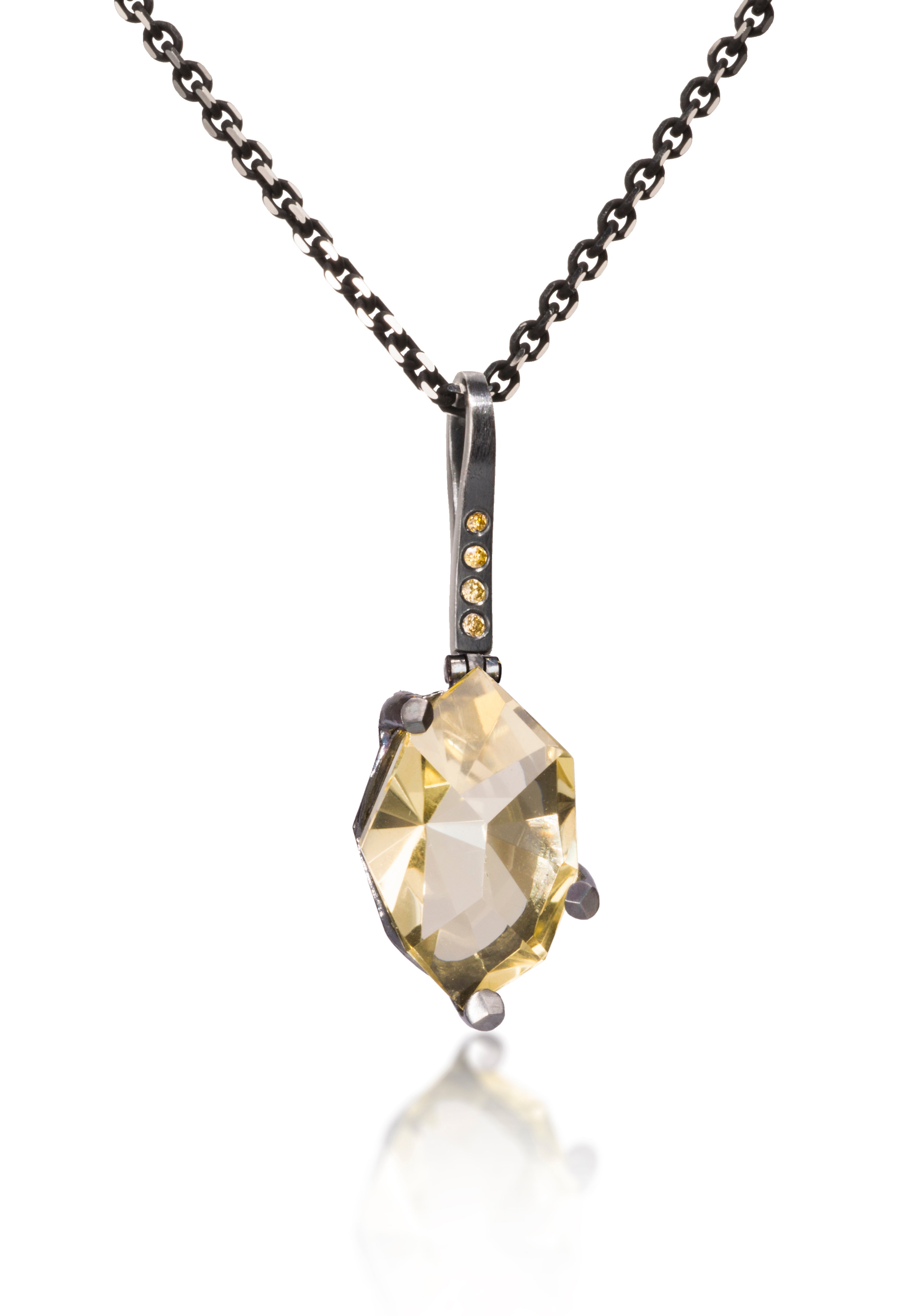 This small size Facets pendant is natural gemstone set in oxidized silver. Unique, hand cut, faceted chunks of gemstone are set in faceted prongs of oxidized silver, hanging from a small bail set with four color coordinated diamonds. Available in six color ways. Gemstone 7.0+ tcw, Dia. 0.0276 tcw.