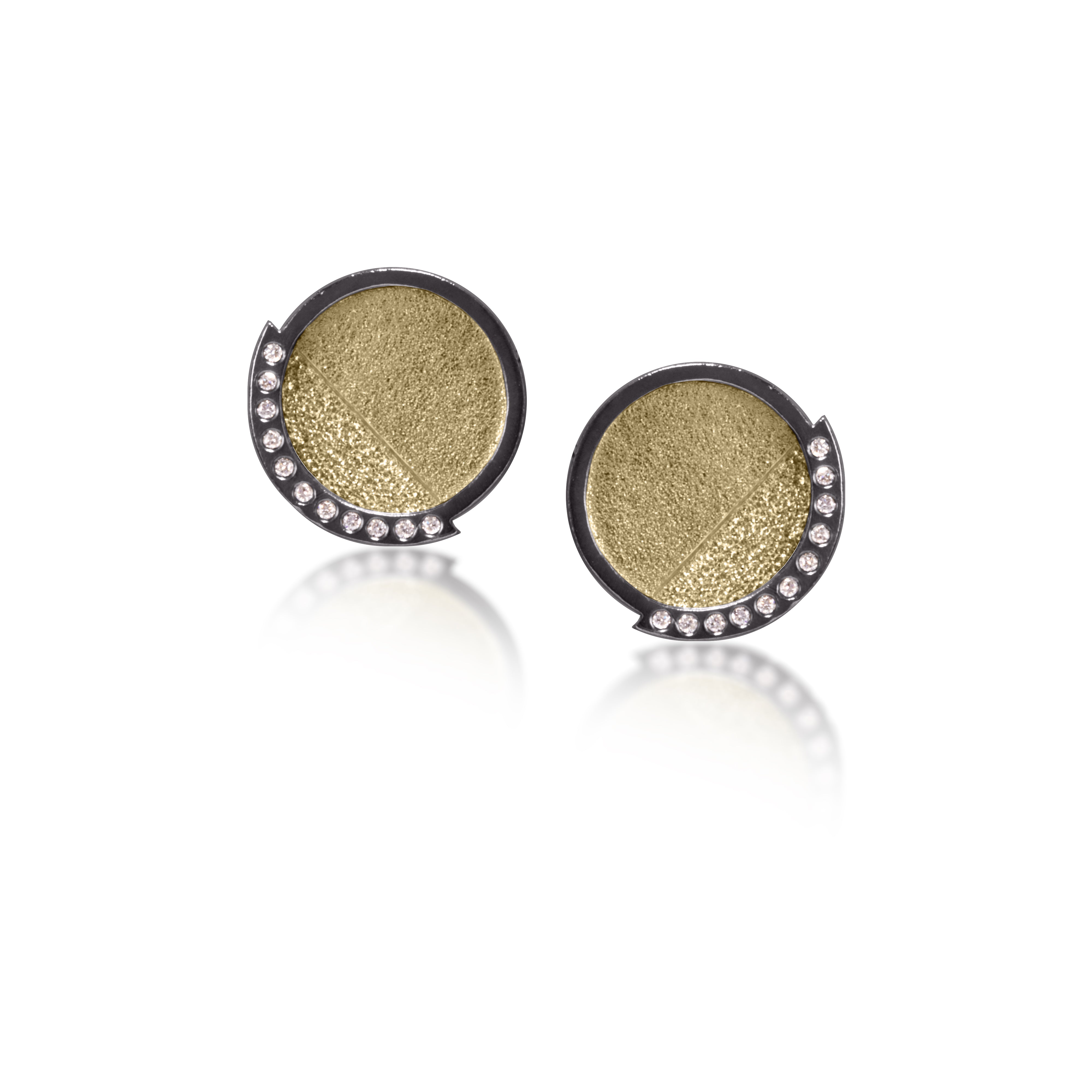 This post earring in oxidized sterling silver and richly textured 18k bimetal, is flush set with ideal cut white diamonds. It features 14k gold posts. Accent facet glitters with the texture of diamond facets, individually scored and textured.  Medium size 0.069 tcw, small size 0.1518 tcw.