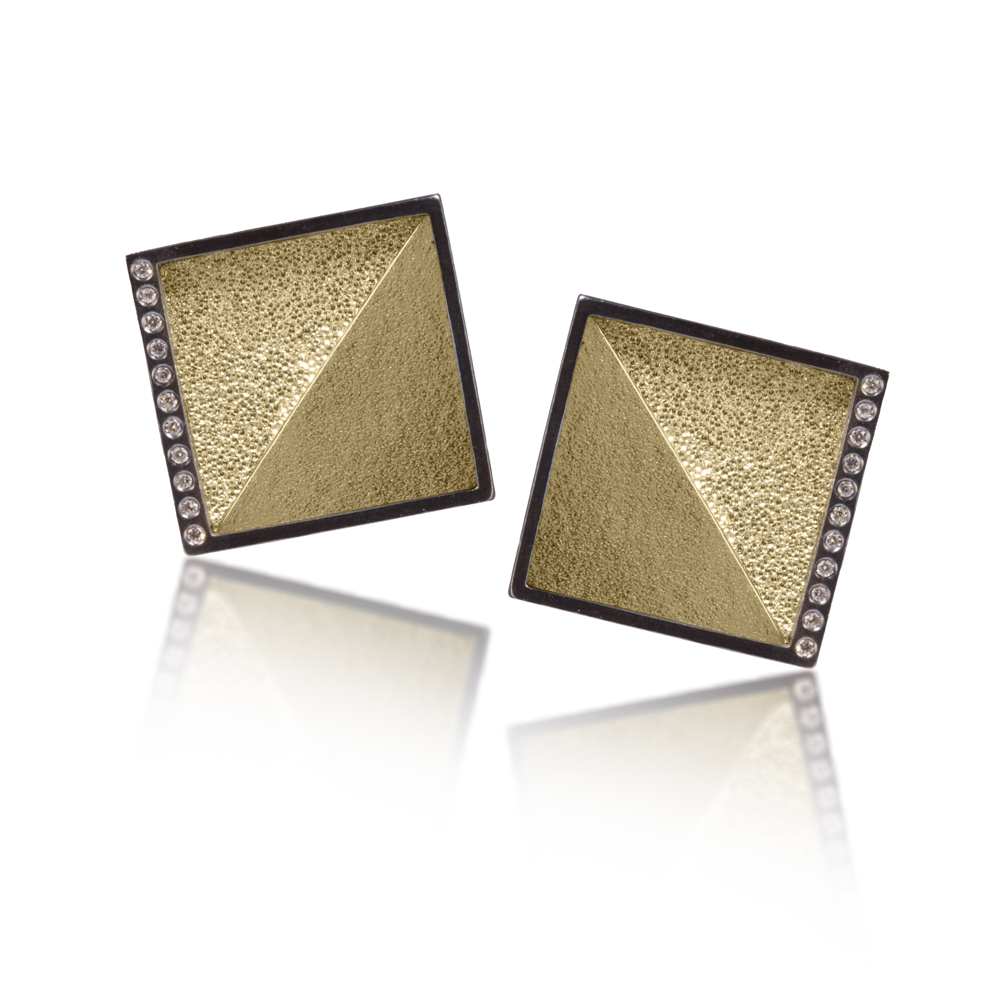 This square post earring in oxidized silver and richly textured 18k bimetal, is flush set with ideal cut white diamonds. It features 14k gold posts. Accent facet glitters with the texture of diamond facets, individually scored and textured. Medium size 0.147 tcw, small size 0.072 tcw.