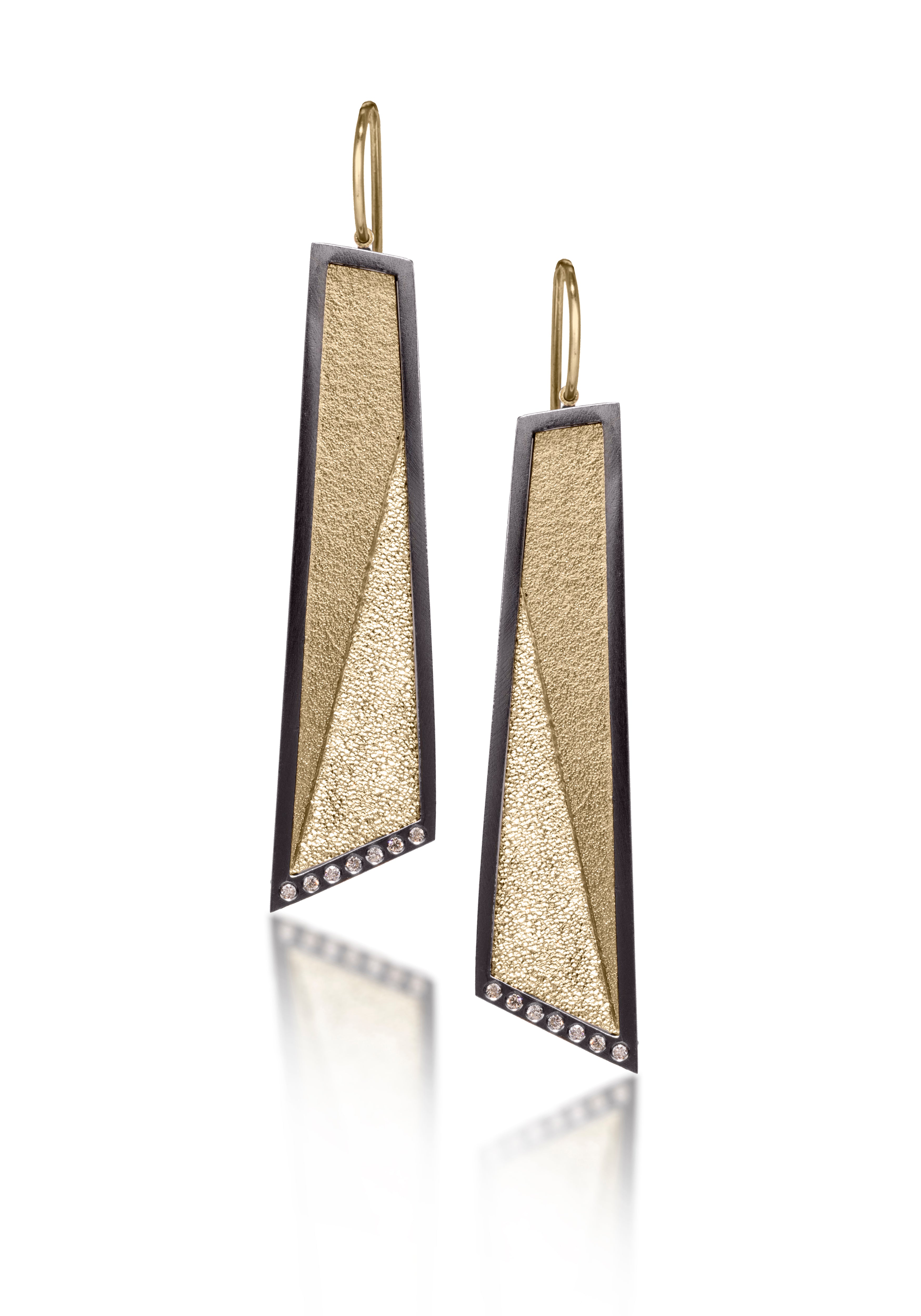 This earring in oxidized sterling silver and richly textured 18k bimetal, is flush set with ideal cut white diamonds. It features 14k gold posts or 18k gold ear wires. Accent facet glitters with the texture of diamond facets, individually scored and textured. Elongated shape, size large. Available in post, post fringe, drop and drop fringe styles.  0.0966 tcw