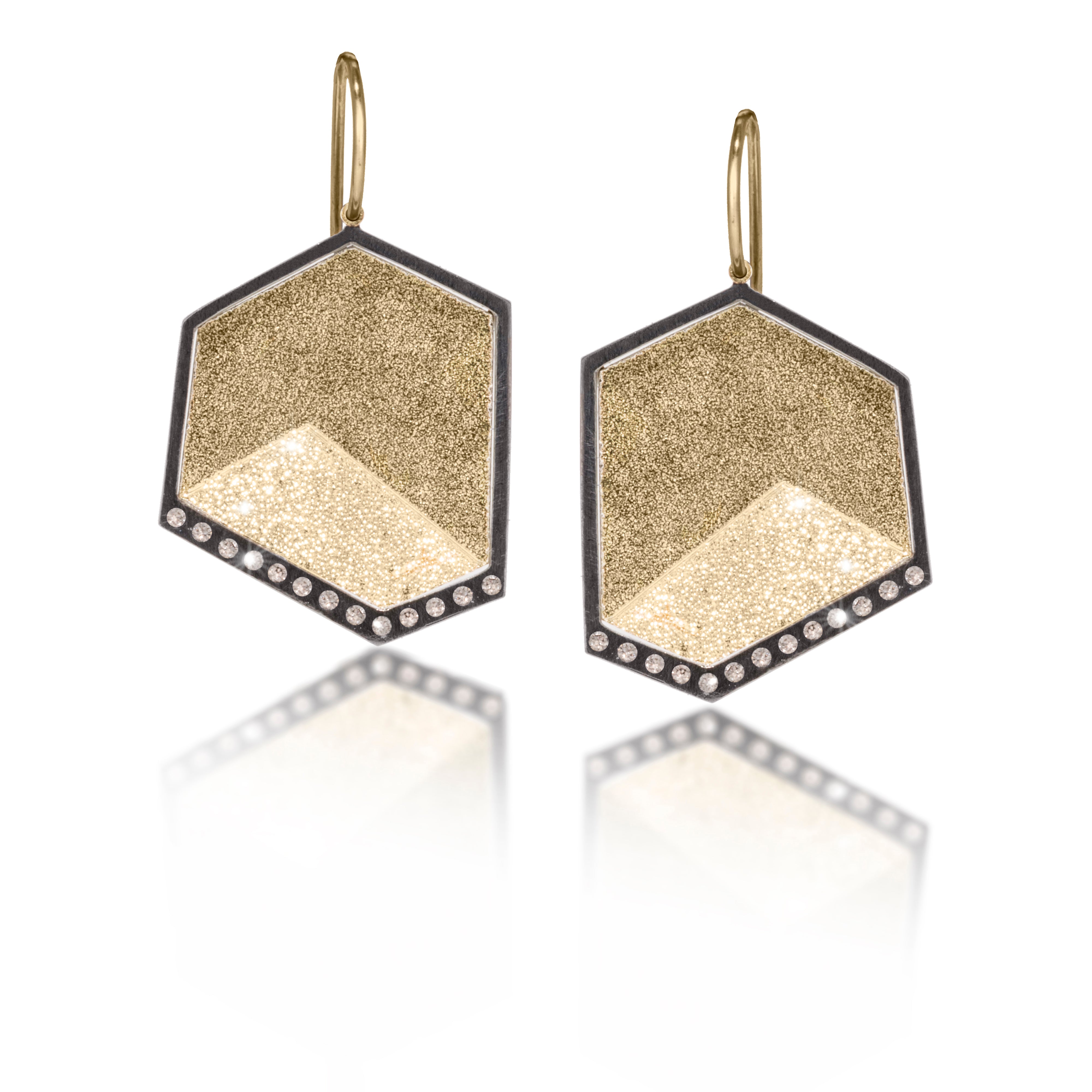 This earring in oxidized sterling silver and richly textured 18k bimetal, is flush set with ideal cut white diamonds. It features 14k gold posts or 18k gold ear wires. Accent facet glitters with the texture of diamond facets, individually scored and textured. Medium size. Available in post, post fringe, drop and drop fringe styles. 0.1794 tcw