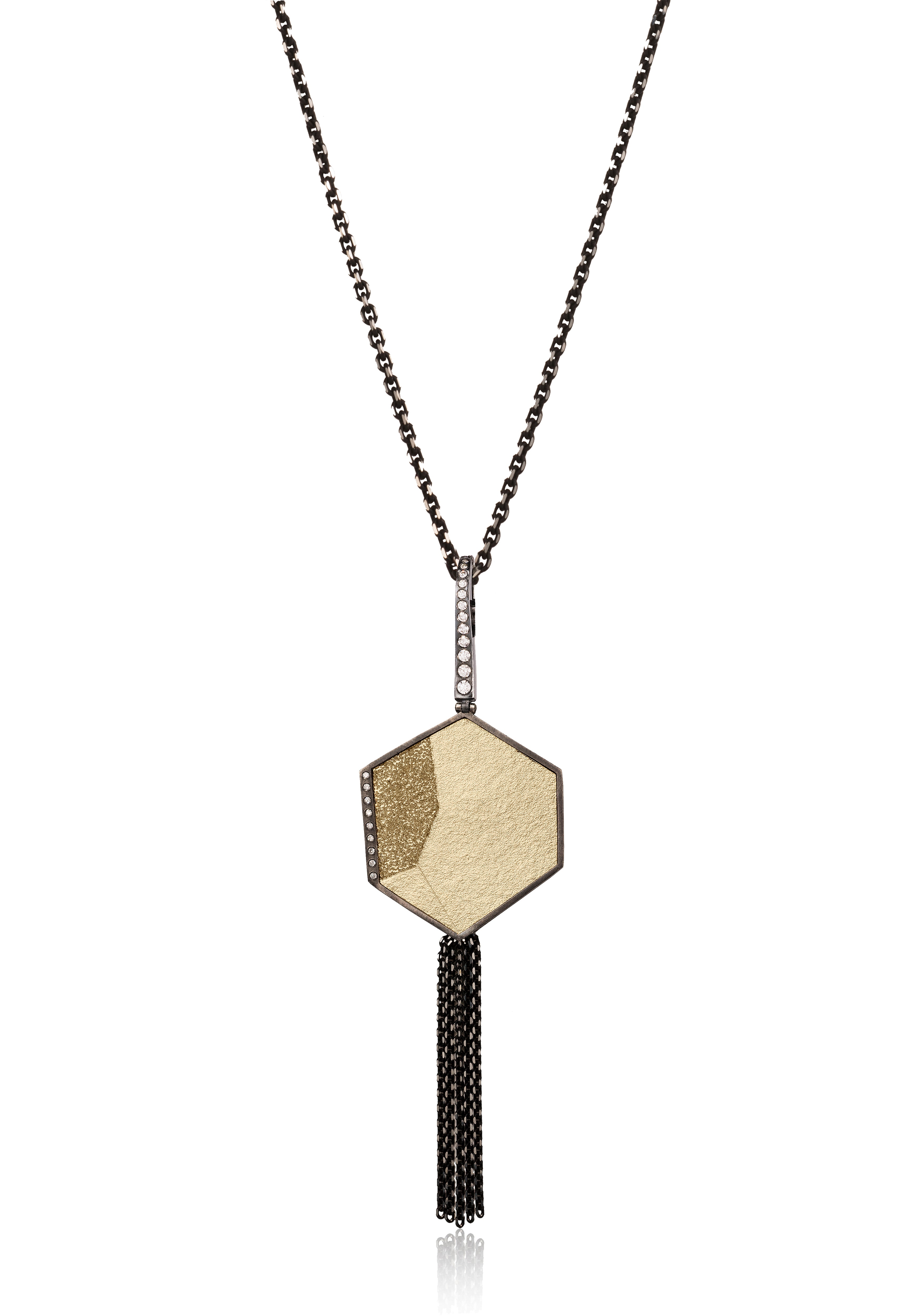 An elegant pendant in oxidized sterling silver and richly textured 18k bimetal is flush set with ideal cut white diamonds. Hinged enhancer bail of oxidized sterling, set with graduated white diamonds. Accent facet glitters with the texture of diamond facets, individually scored and textured. Size large with a long diamond cut chain fringe tassel. 0.2211 tcw