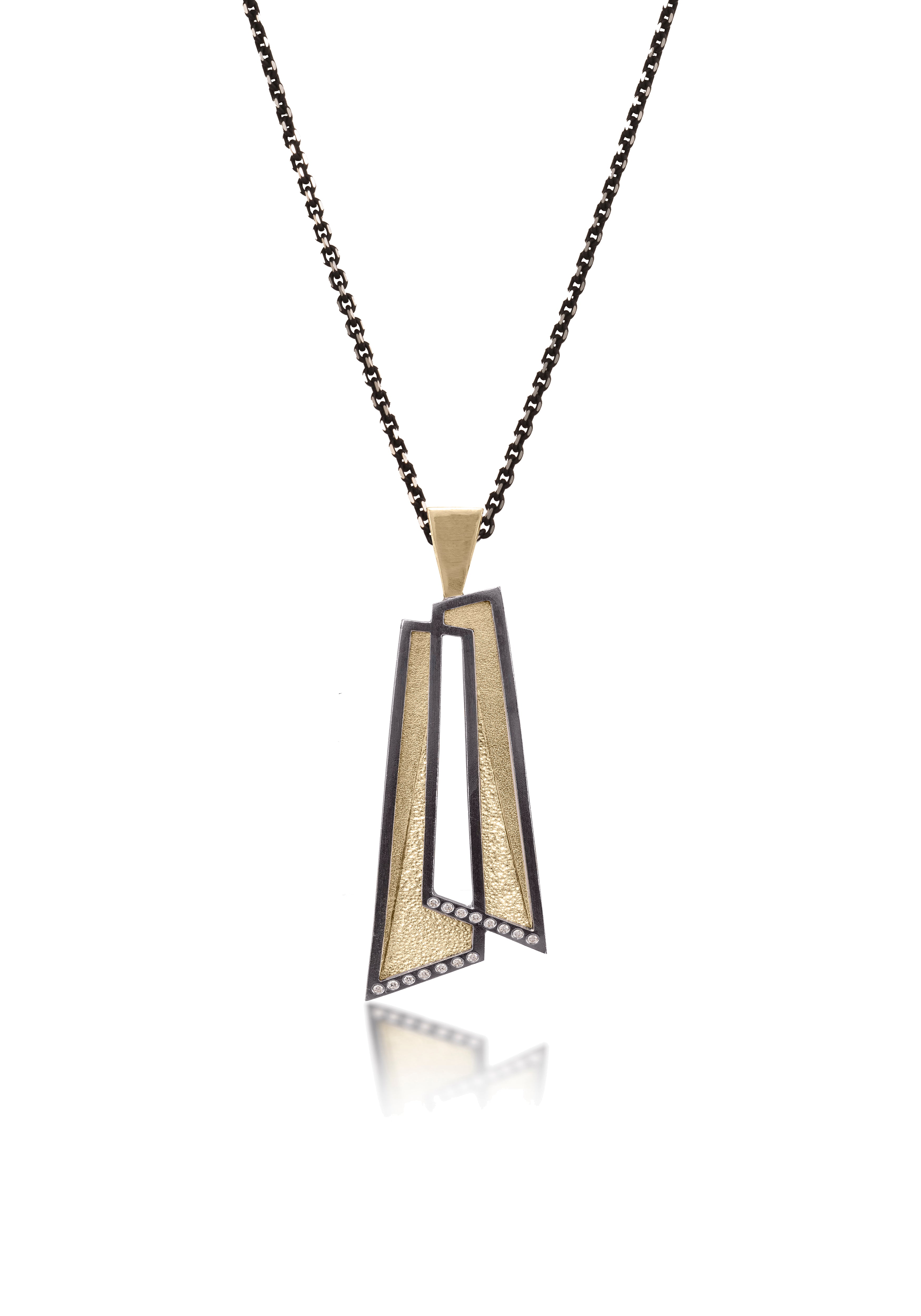 This oxidized sterling silver and richly textured 18k bimetal pendant is flush set with ideal cut white diamonds. Accent facet glitters with the texture of diamond facets, individually scored and textured. Overlapping shapes with open areas. Available with oxidized silver or 18k gold bail. 0.0483 tcw
