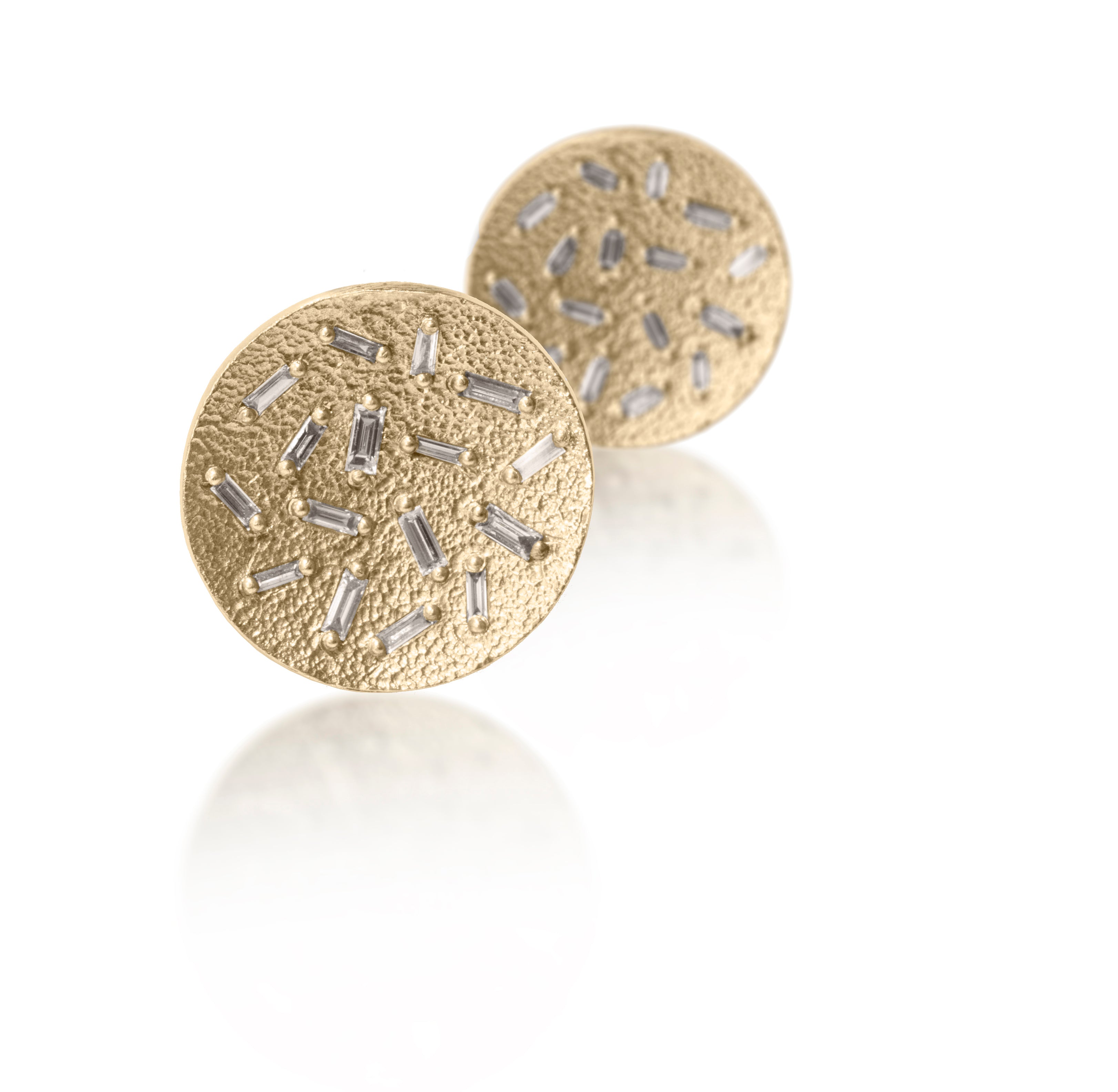 This simple but dramatic post earring is perfect for everyday. Offered in three richly textured color ways, oxidized sterling, 18k gold, palladium. Each earring is set with 16 white diamond baguettes. 0.87 tcw.