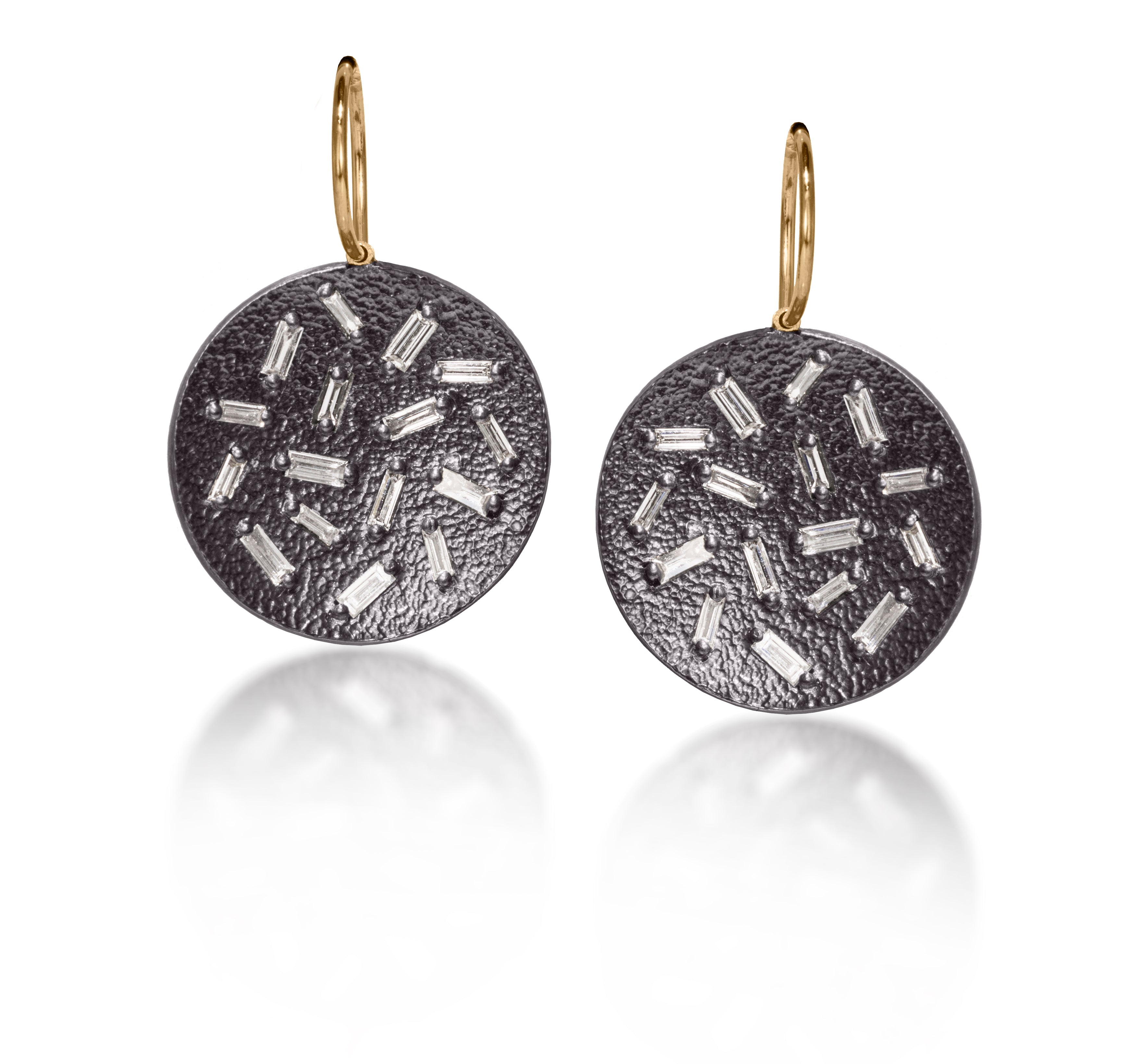 This simple but dramatic drop earring is perfect for everyday.  Offered in three richly textured color ways, oxidized sterling, 18k gold, palladium.  Each earring set with 16 white diamond baguettes. 0.87 tcw.