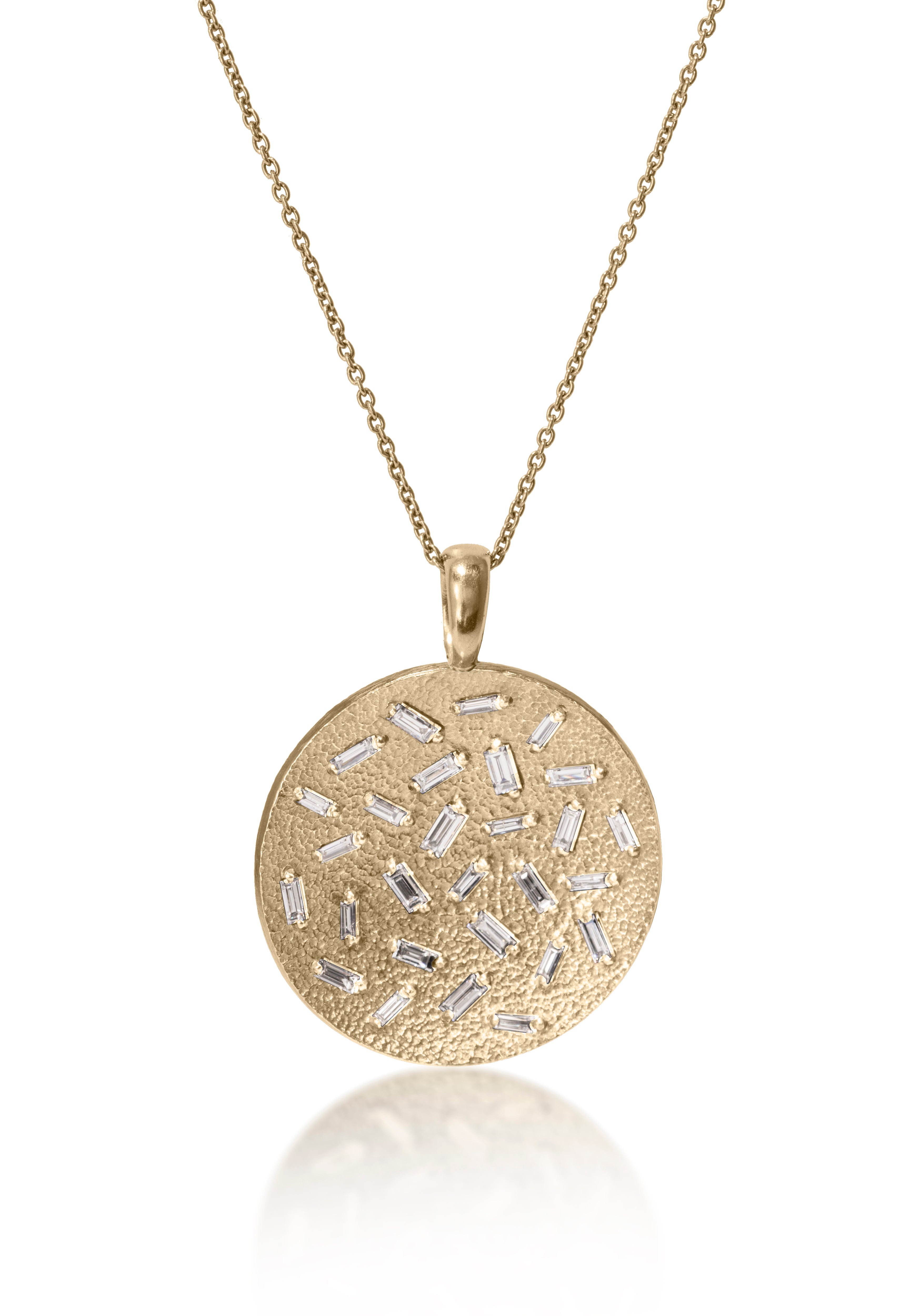 This large, radiant pendant is set with a stunning 28 white diamond baguettes. Richly textured to shimmer in the light, this piece is available in three color ways, oxidized silver, 18k gold and palladium. 0.773 tcw.