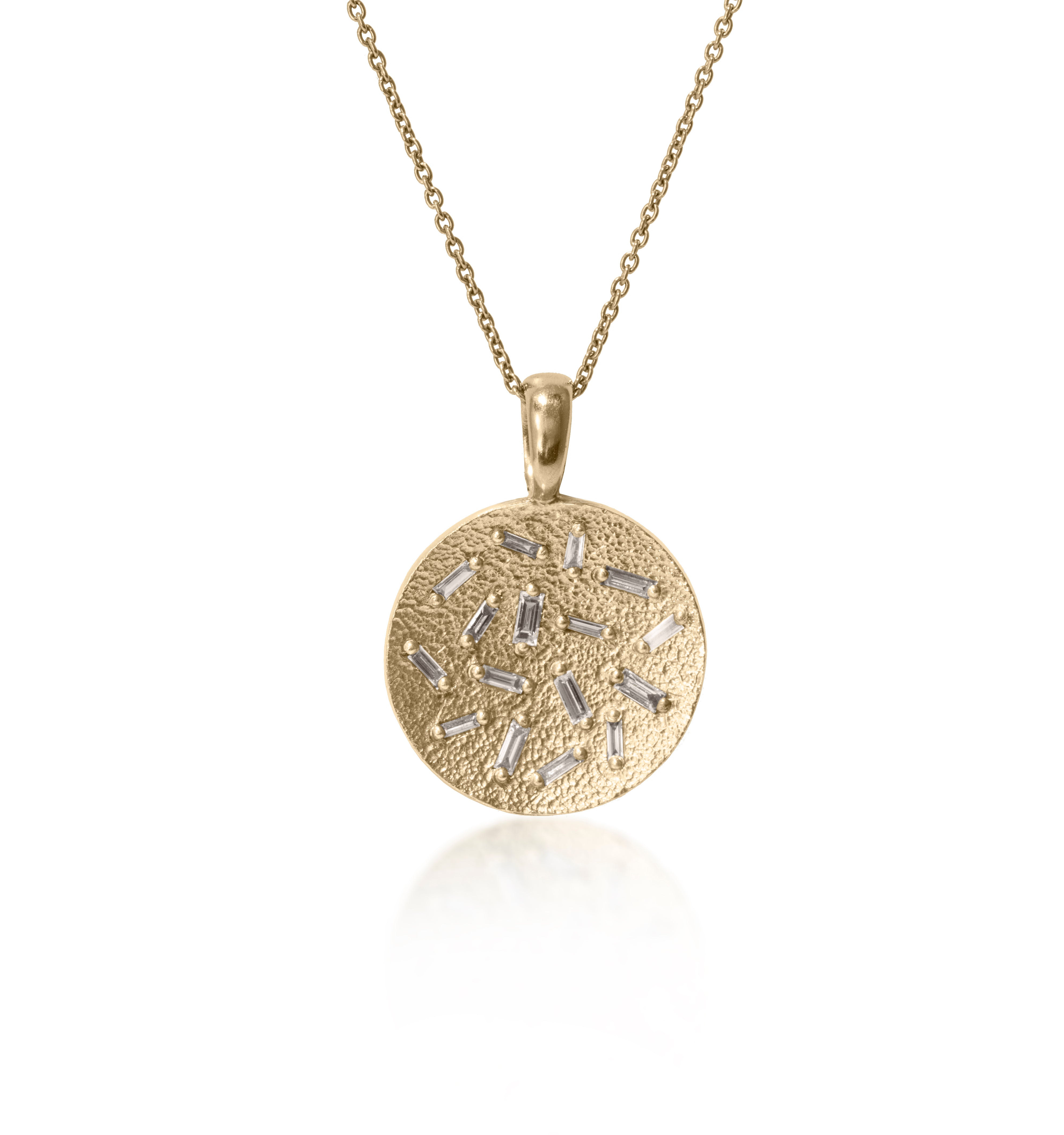 This radiant, medium size circular pendant is set with 16 white diamond baguettes. Richly textured to shimmer in the light, this piece is available in three color ways, oxidized silver, 18k gold and palladium.  0.435 tcw.