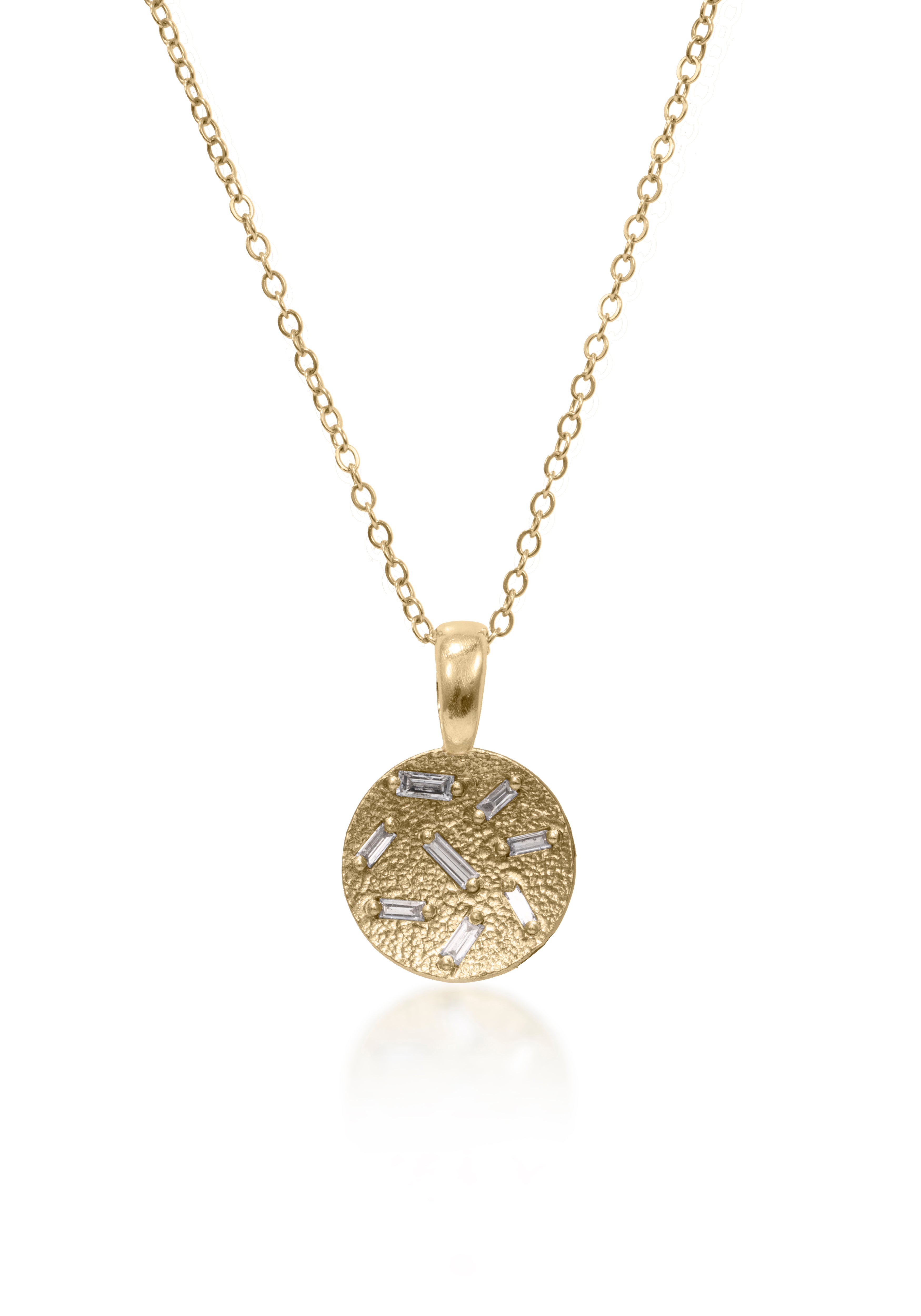 This stunning, small circular pendant is set with 8 white diamond baguettes. Richly textured to shimmer in the light, this piece is available in three color ways, oxidized silver, 18k gold and palladium.  0.227 tcw.