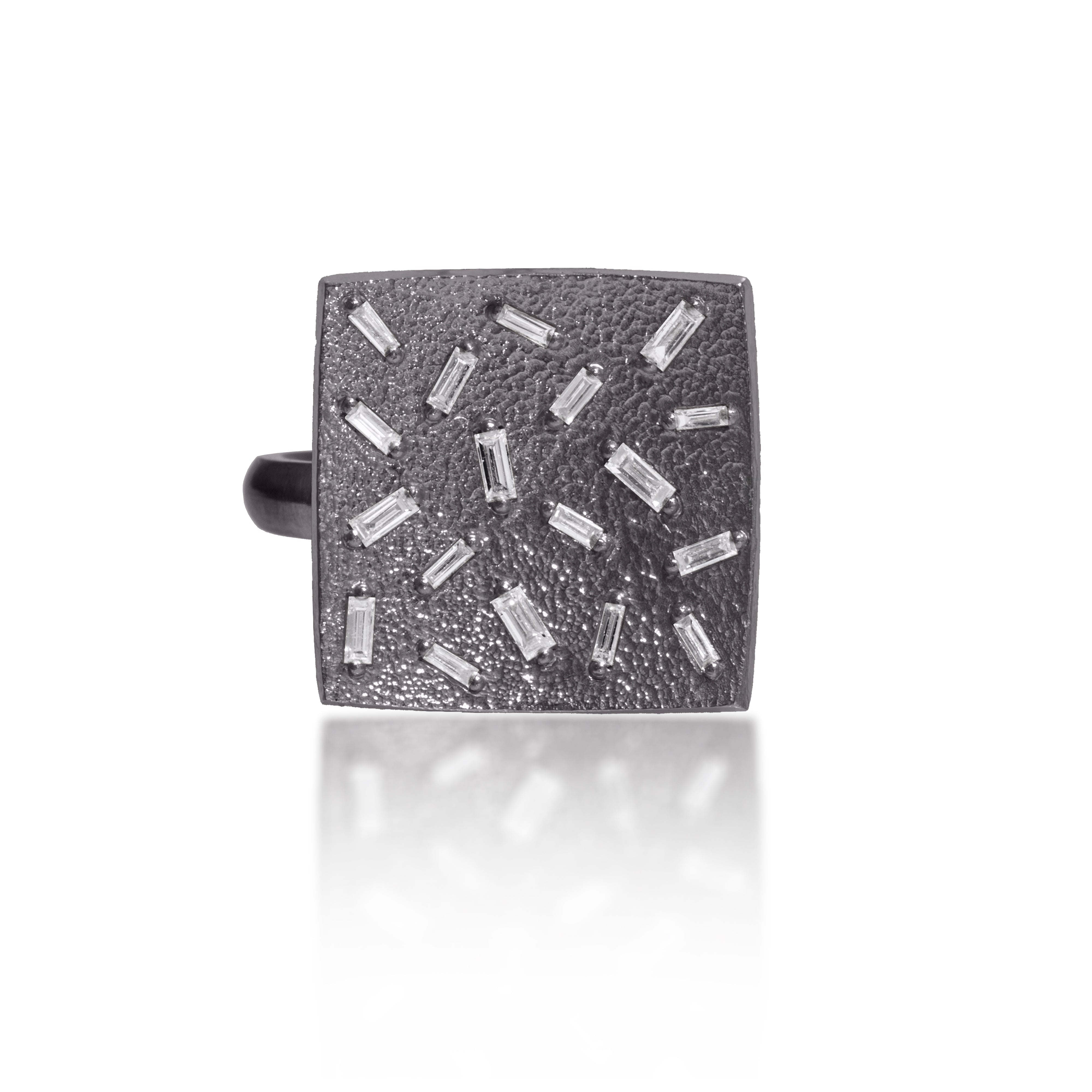 This medium square pendant ring in oxidized sterling silver is set with 18 white diamond baguettes. It is available in three richly textured color ways, oxidized silver, 18k gold, and palladium.  The random angles of the baguettes catch the light in exciting ways when worn. 0.486 tcw.