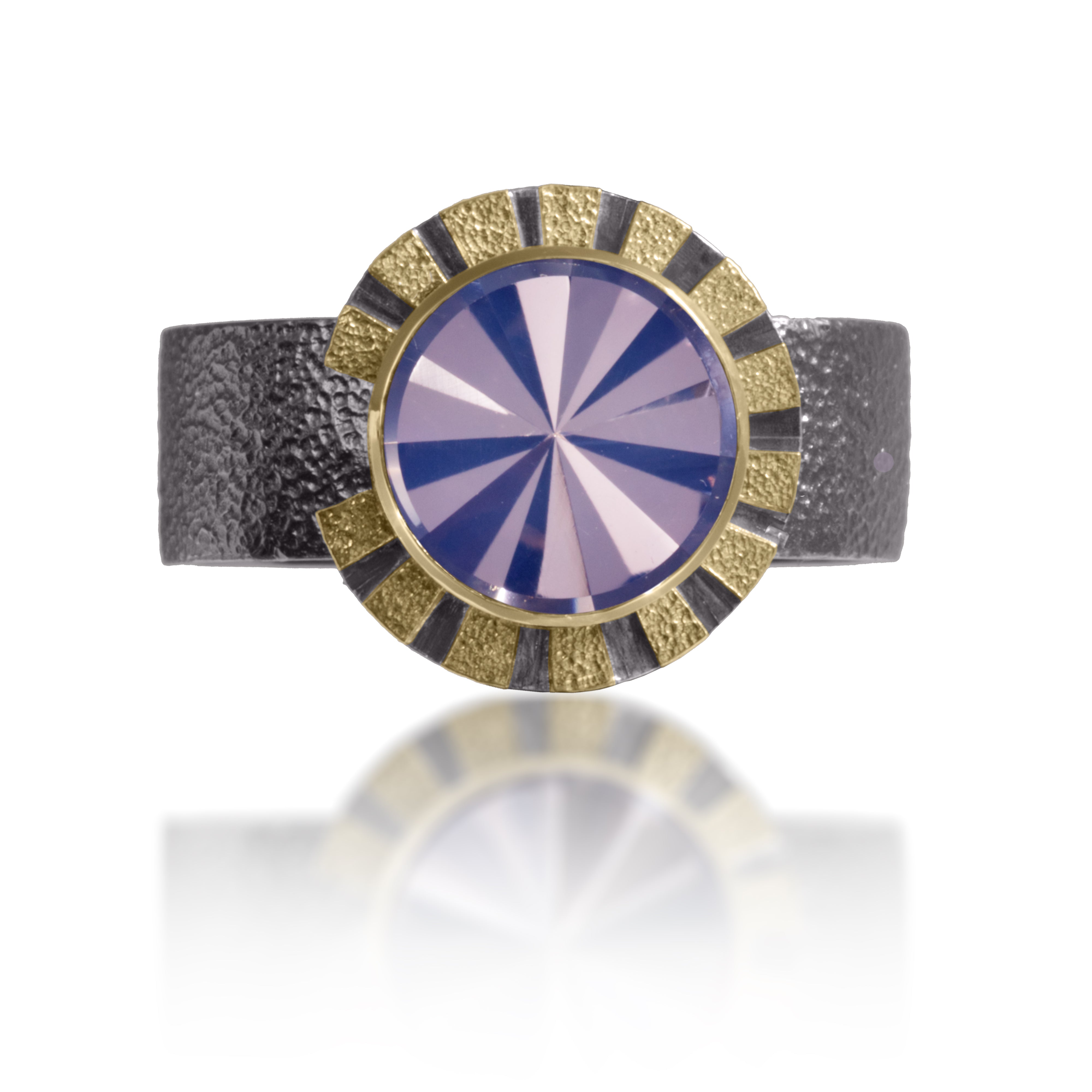 Stripe Ring #1 in 18k gold and oxidized sterling silver with a bezel set radial cut, semiprecious center stone. Hand fabricated, stipple textured and engraved mixed metals. Textured band with rounded “comfort” contour.