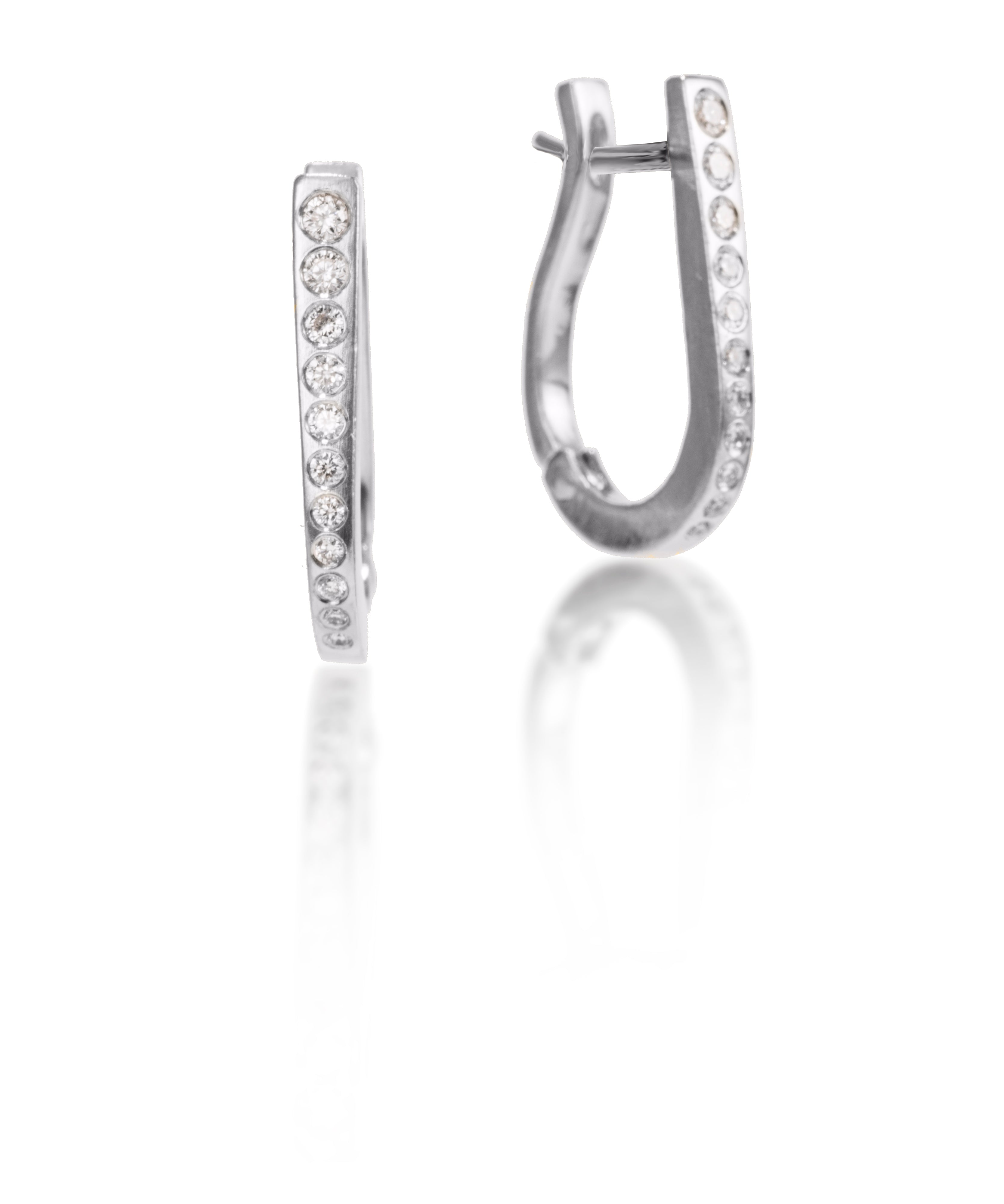 These simple, but elegant horseshoe shaped hoops are great on their own or accented with gem as a drop earring.  They feature cascading white diamonds, 0.318 tcw., and a built in closure that snaps securely closed.  Available in four color ways, oxidized silver, 18k gold, palladium or platinum.