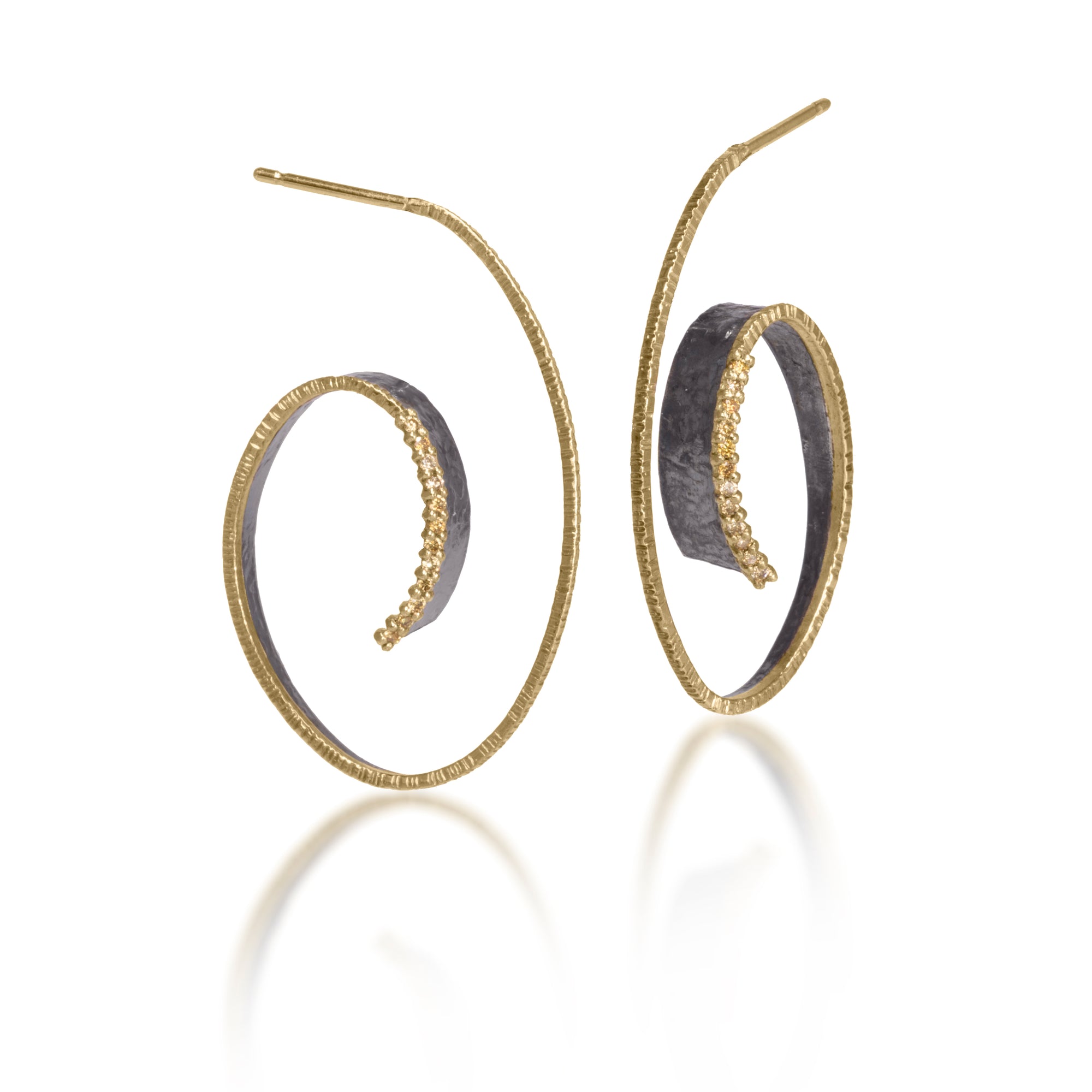 This best-selling Cyclone Earring is created in 18k gold and oxidized sterling silver with prong set natural yellow diamonds.   A diamond and textured gold rim brings light and dimension to this dazzling hoop.   Hand fabricated, hammer textured. 0.1728 tcw.