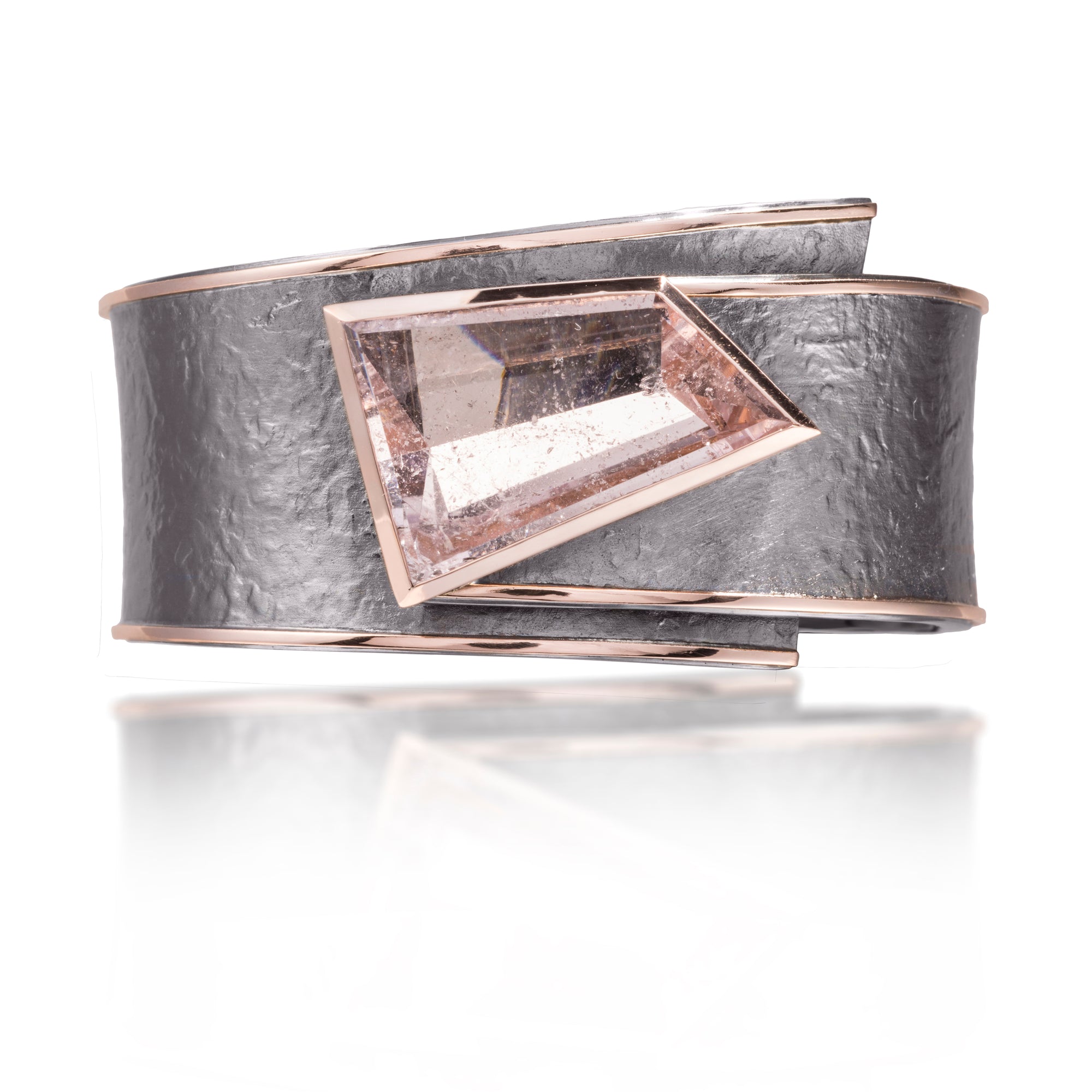 This one-of-a-kind Cyclone Cuff in 18k gold and oxidized silver is bezel set with a dramatic, mirror-cut Morganite.  A hinge on the back side of this tapered cuff allows it to fully open, making it incredibly easy to put on and off with one hand. Wide, wrap-around style cuff, hand fabricated, spring steel hinge, hammer textured.  Morganite 34.60 tcw.
