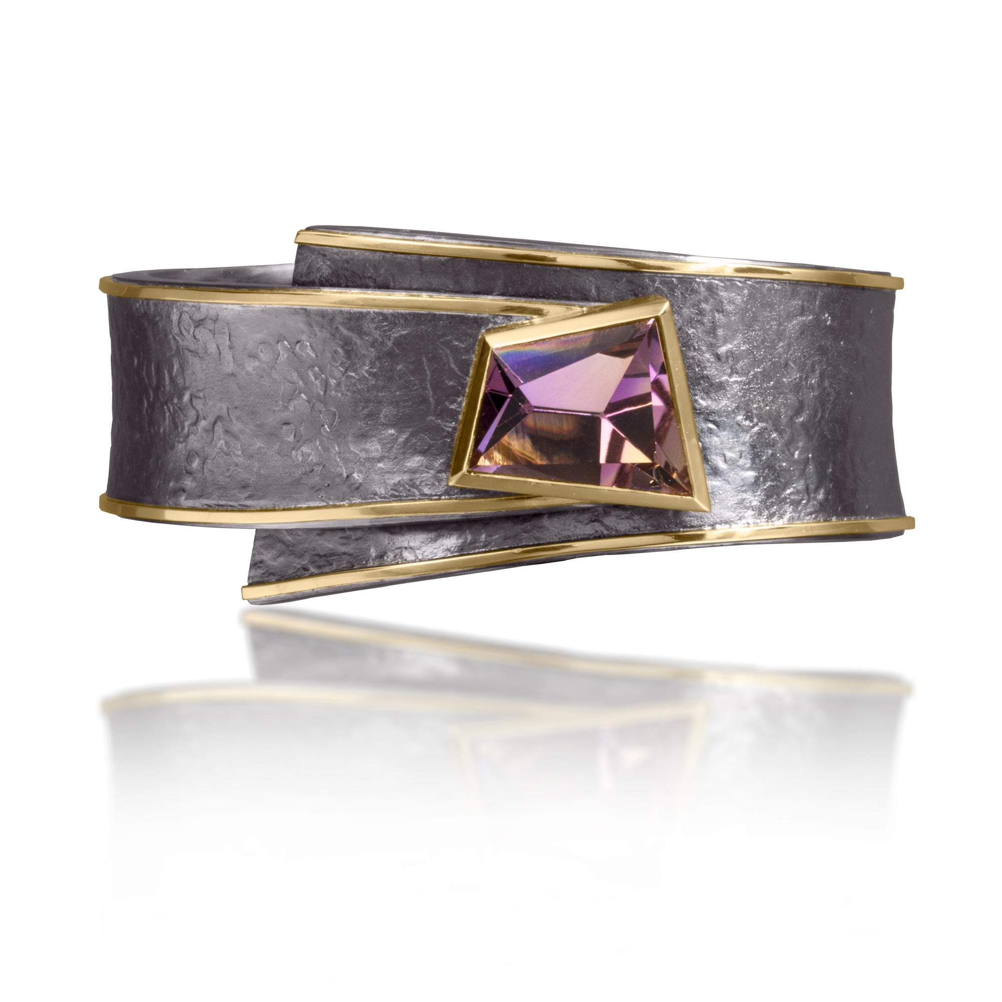 This one-of-a-kind Cyclone Cuff in 18k gold and oxidized silver is bezel set with an unusual, mirror-cut Ametrine. A hinge on the back side of this tapered cuff allows it to fully open, making it incredibly easy to put on and off with one hand. Wide, wrap-around style cuff, hand fabricated, spring steel hinge, hammer textured.