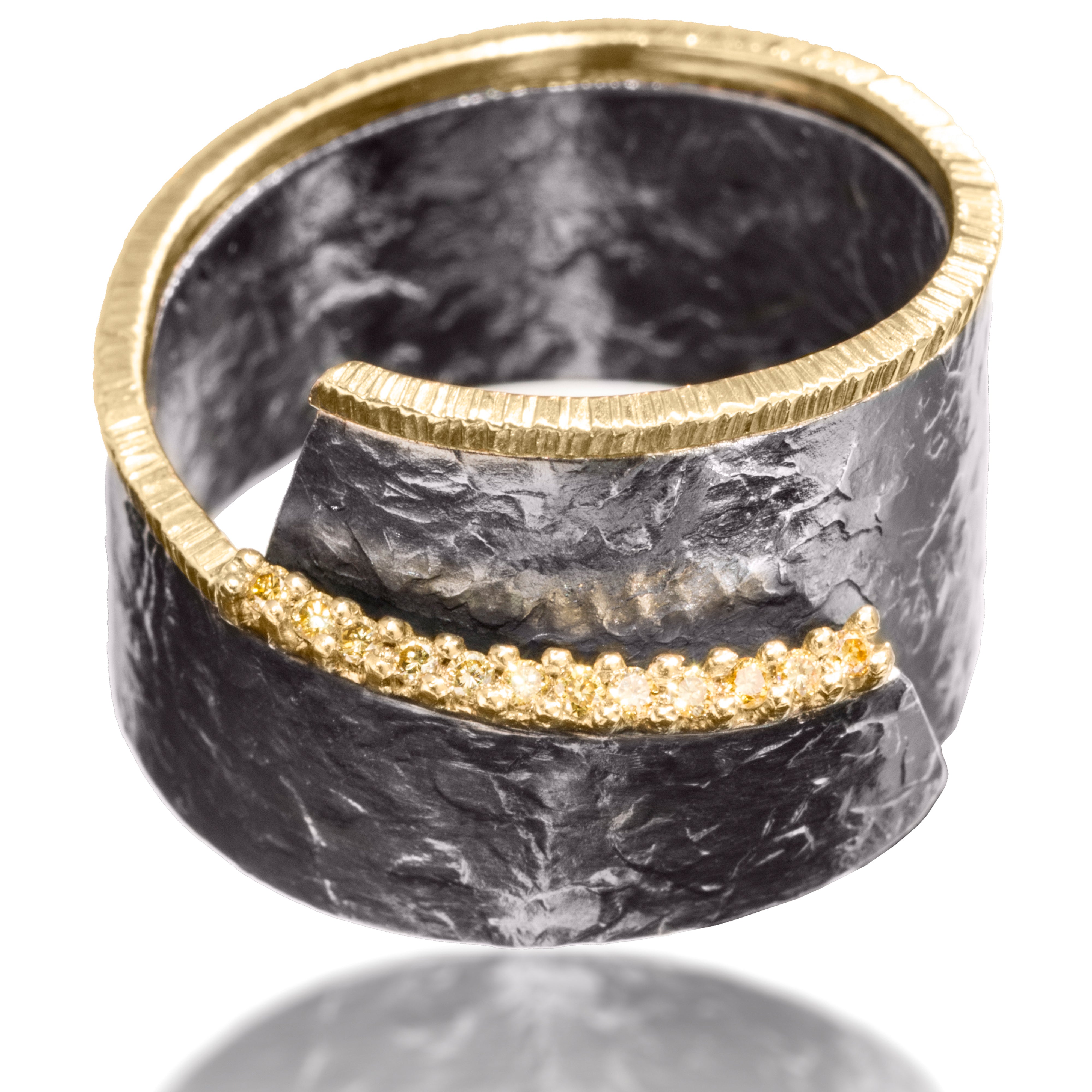 This unique and popular wrap around Cyclone ring in 18k gold and oxidized silver is available with or without prong set natural yellow diamonds. Diamonds set on a 45 degree angle to bring light and brilliance to the stones.  Hand fabricated, hammer textured. 0.0864 tcw.