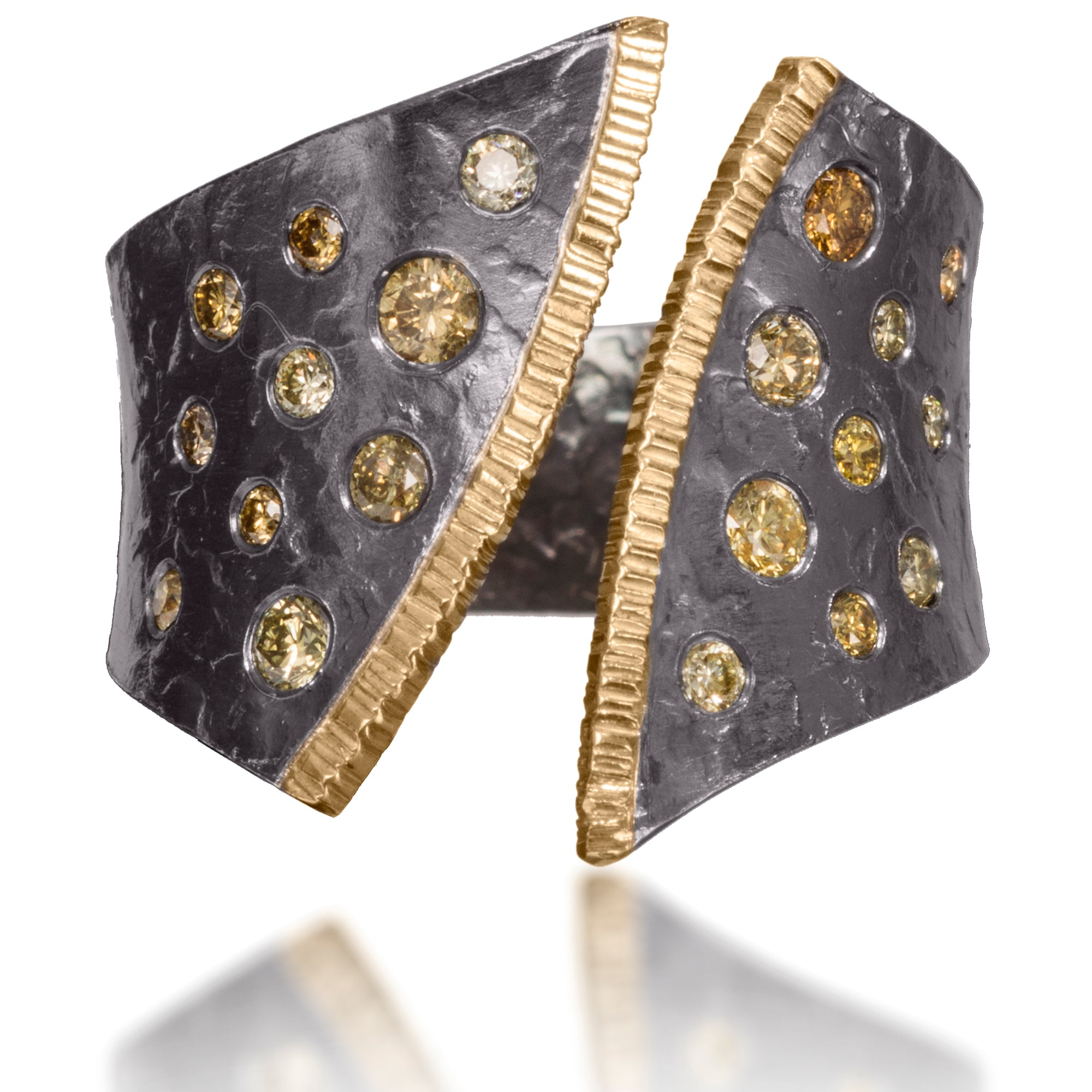 This dazzling ring has been created in 18k gold and oxidized silver and is flush set assorted diamonds It is hand fabricated and features a hammered textured. Currently available in four color ways. As shown, 0.50 tcw.