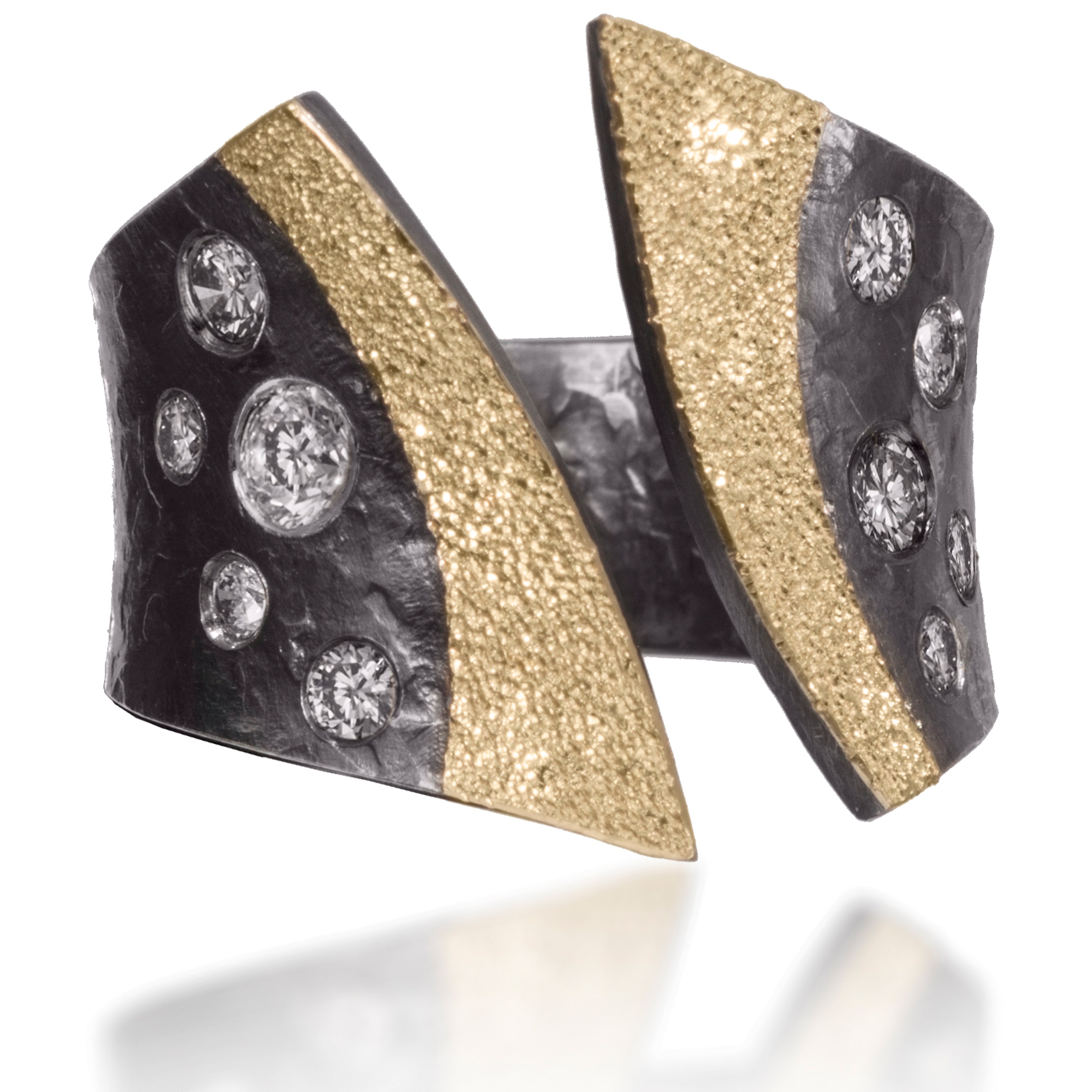 This scintillating variation is nicknamed "tuxedo". Created in 18k gold and oxidized silver, the "tuxedo lapels" are texture with a diamond and framed by flush set assorted diamonds.  It is hand forged and fabricated.  Available in white or gray diamonds.  As shown, 0.25 tcw.