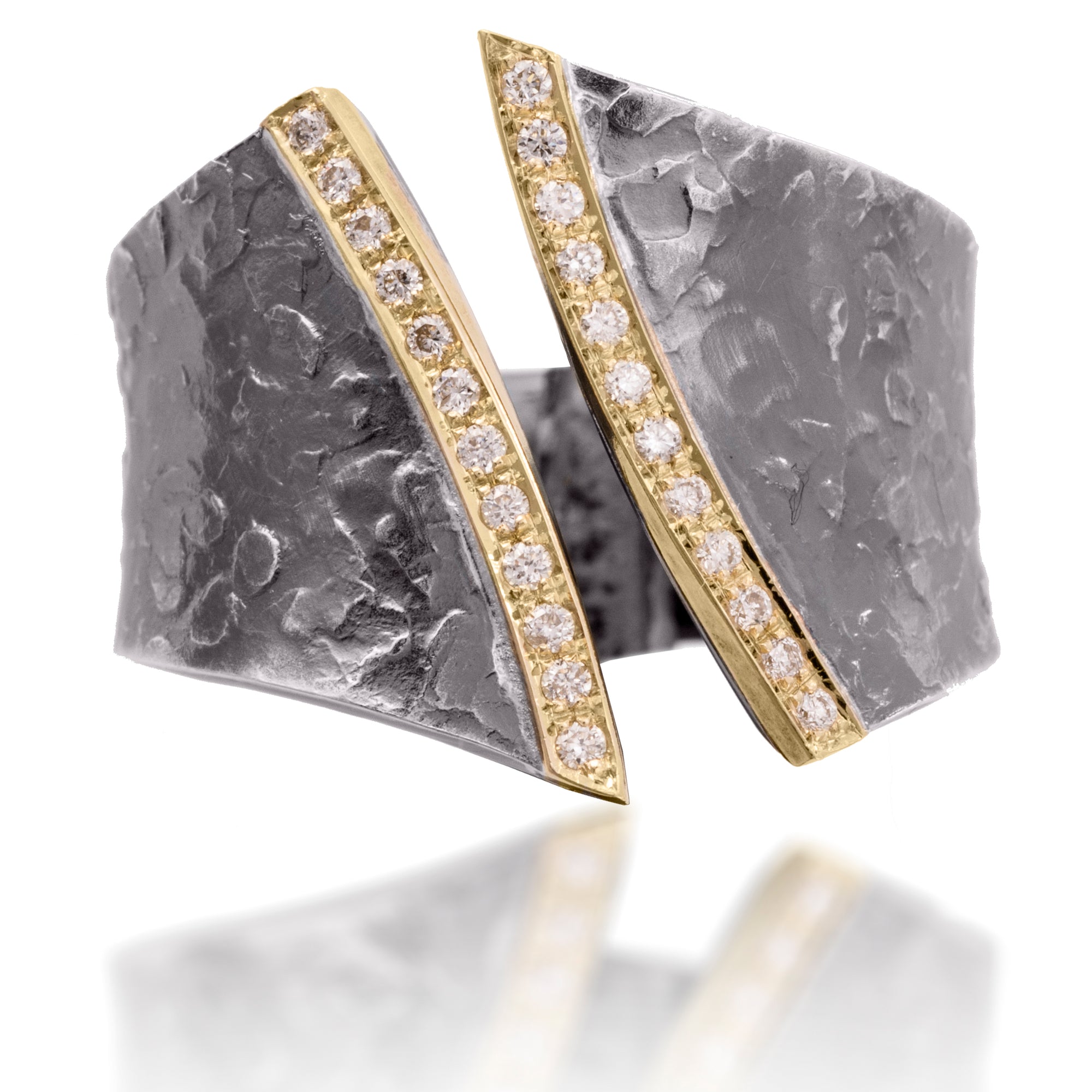 A fresh, modern classic combining earthy textured metals with true bright cut pavé. Hand forged and fabricated in 18k gold and oxidized sterling silver with pavé set white diamonds. As shown, 0.166 tcw.