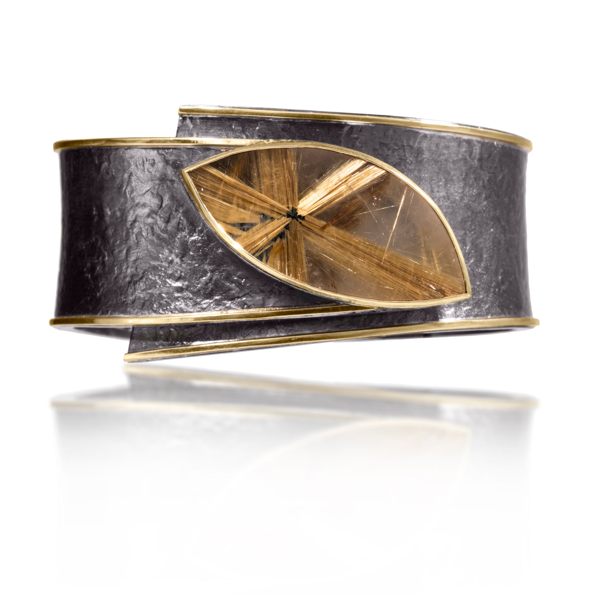 This one-of-a-kind Cyclone Cuff in 18k gold and oxidized silver is bezel set with a large, captivating, star Rutilated Quartz.  A hinge on the back side of this tapered cuff allows it to fully open, making it incredibly easy to put on and off with one hand. Wide, wrap-around style cuff, hand fabricated, spring steel hinge, hammer textured. Rutilated Quartz 35.61 tcw.