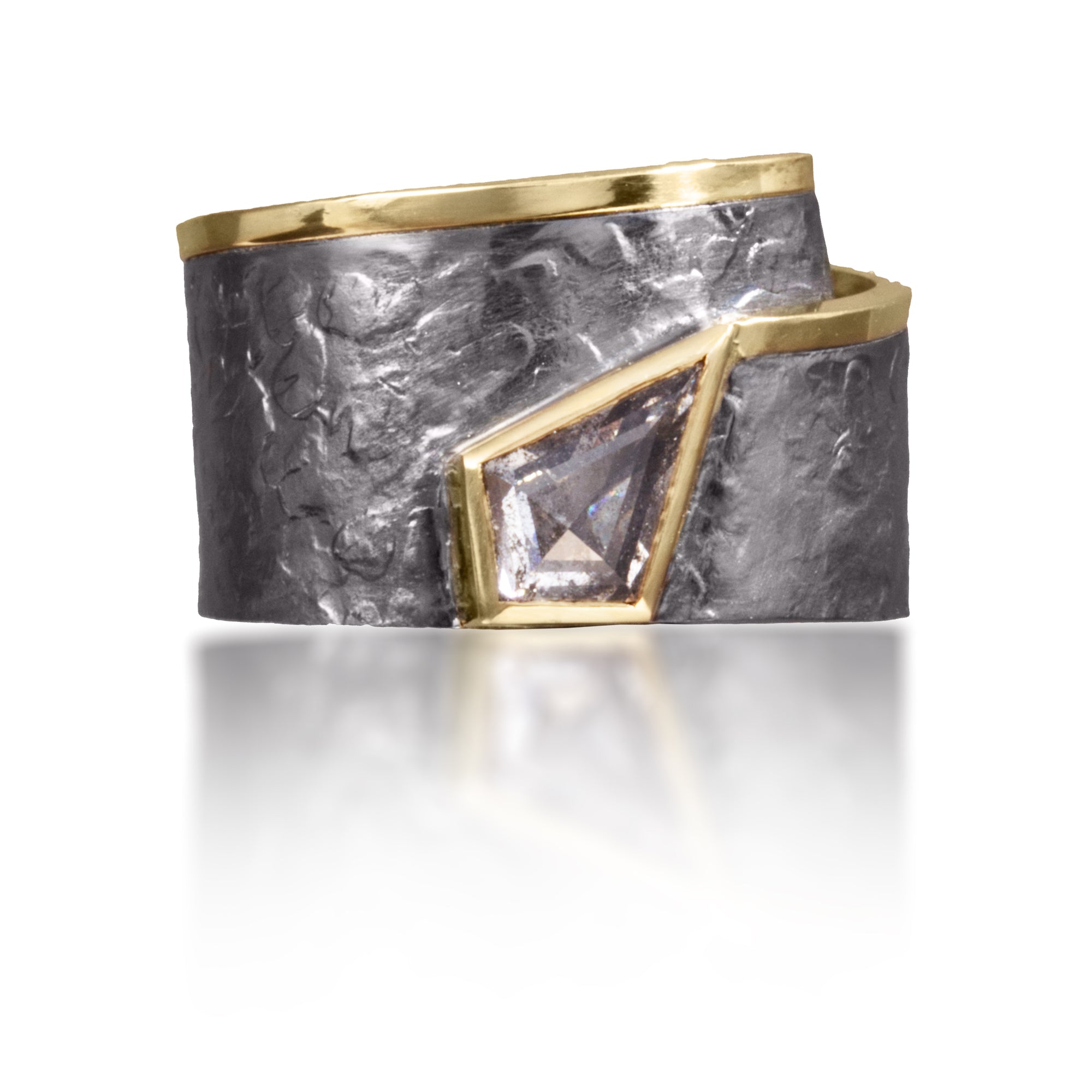 This simple, yet distinctive, one of kind ring in 18k gold and oxidized silver features a bezel set, “salt and pepper” diamond, 0.83 tcw.  It is forged, textured and fabricated by hand.  