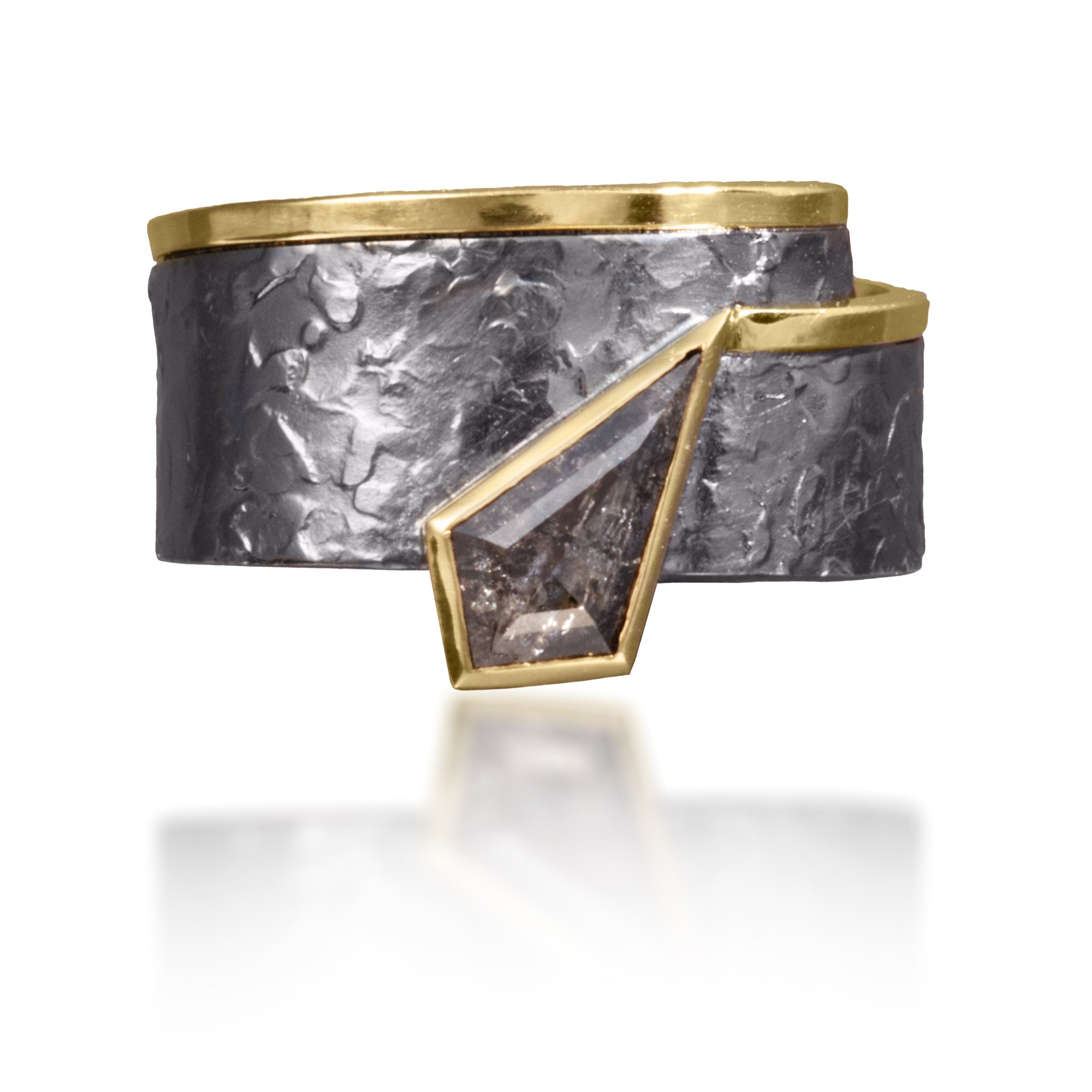 This simple, yet distinctive, one of kind ring in 18k gold and oxidized silver features a bezel set, “salt and pepper” diamond, 0.80 tcw.  It is forged, textured and fabricated by hand. 