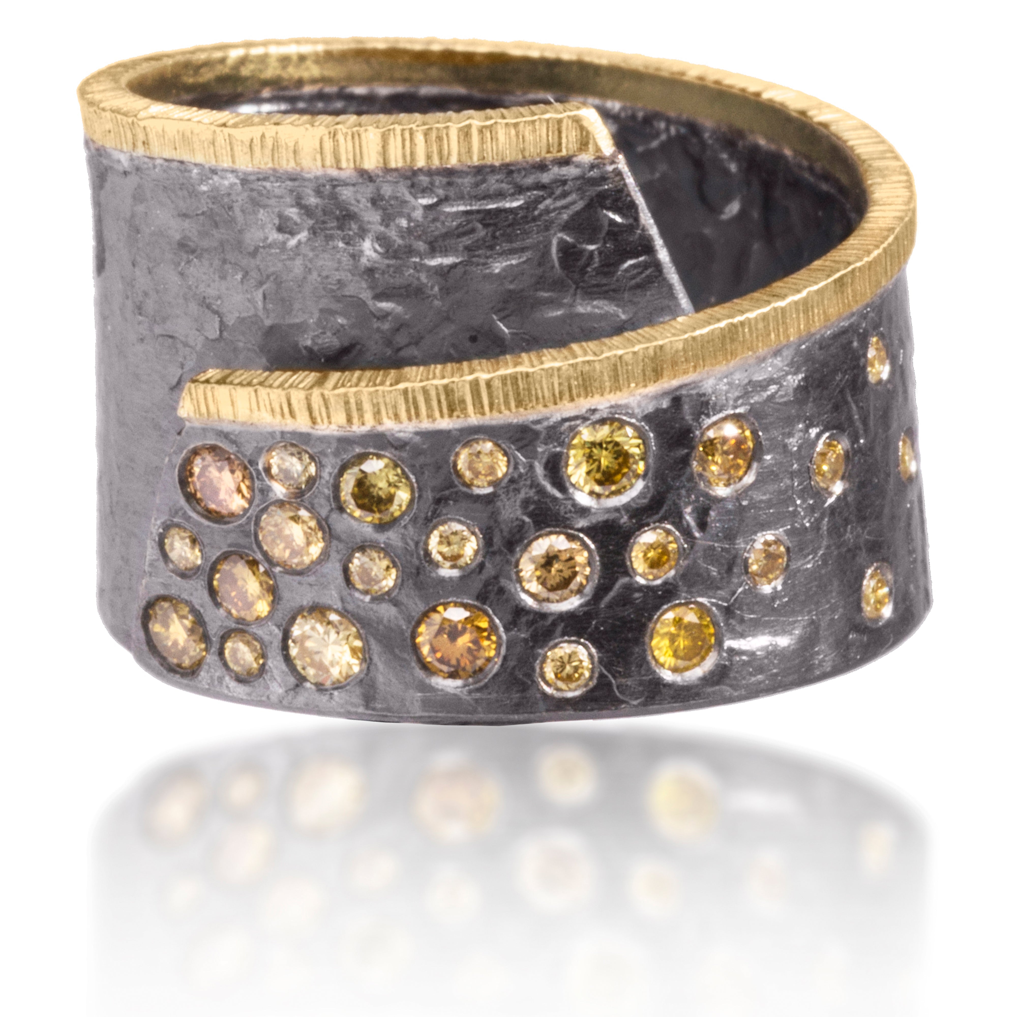This Cyclone diamond spray ring in 18k gold and oxidized silver is with flush set assorted natural diamonds available in 5 color ways. Hand fabricated, hammer textured. As shown, 0.36 tcw