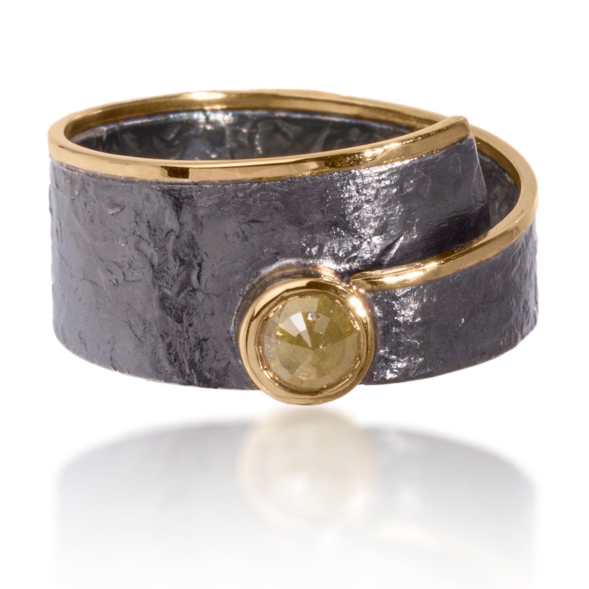 This simple and elegant Cyclone Ring is made of 18k gold and oxidized silver with a bezel set center rose cut, opaque diamond. Hand fabricated, hammer textured. Available in various widths, colors and cuts. 0.28- 0.33 tcw.