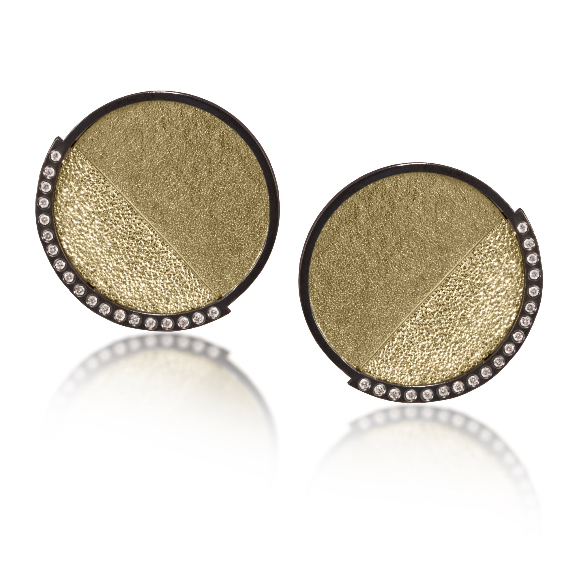 This post earring in oxidized sterling silver and richly textured 18k bimetal, is flush set with ideal cut white diamonds. It features 14k gold posts. Accent facet glitters with the texture of diamond facets, individually scored and textured.  Medium size 0.069 tcw, small size 0.1518 tcw.