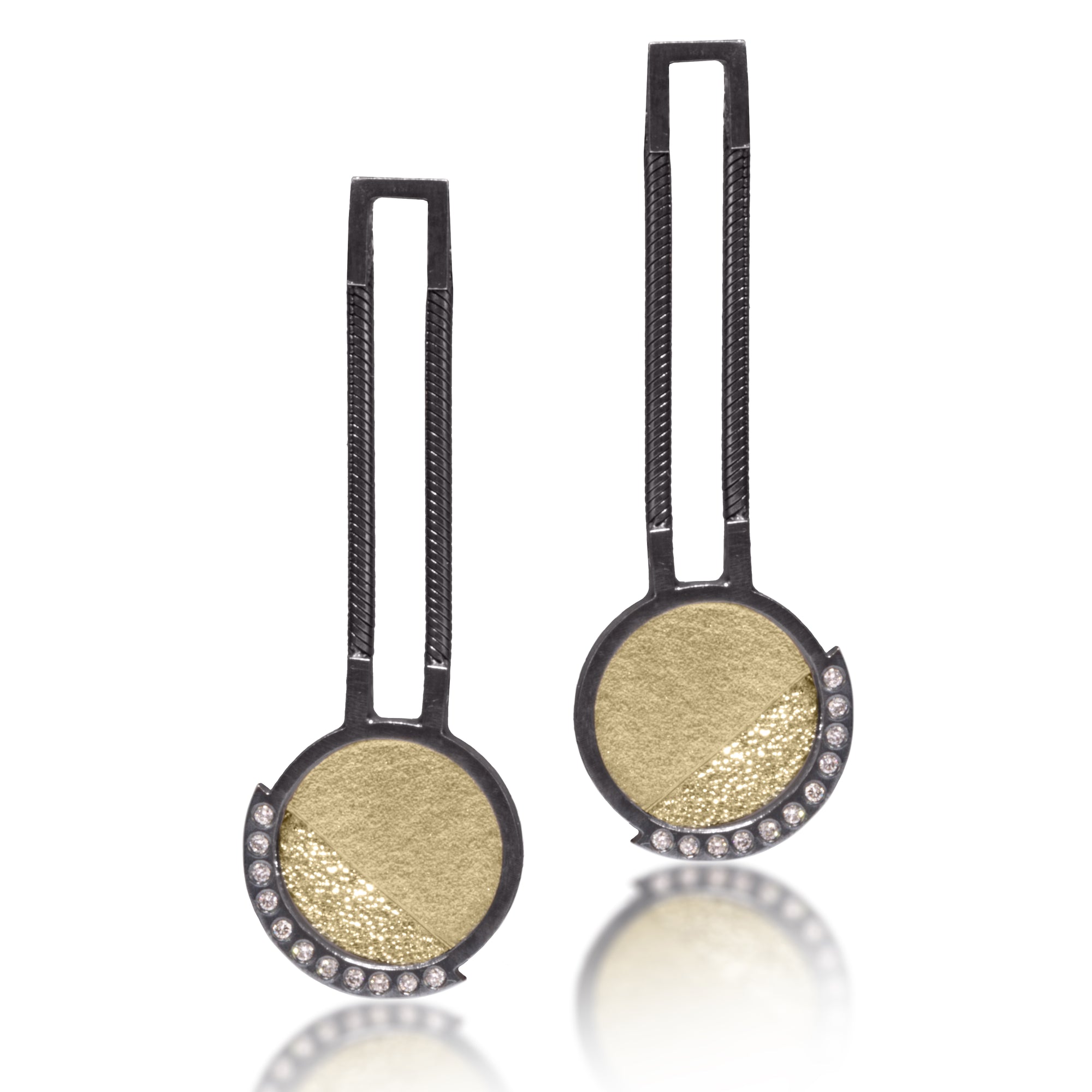 This oxidized sterling silver and richly textured 18k bimetal earring is flush set with ideal cut white diamonds.  Accent facet glitters with the texture of diamond facets, individually scored and textured.  Features 14k posts and flexible chains connecting top to bottom.  0.147 tcw
