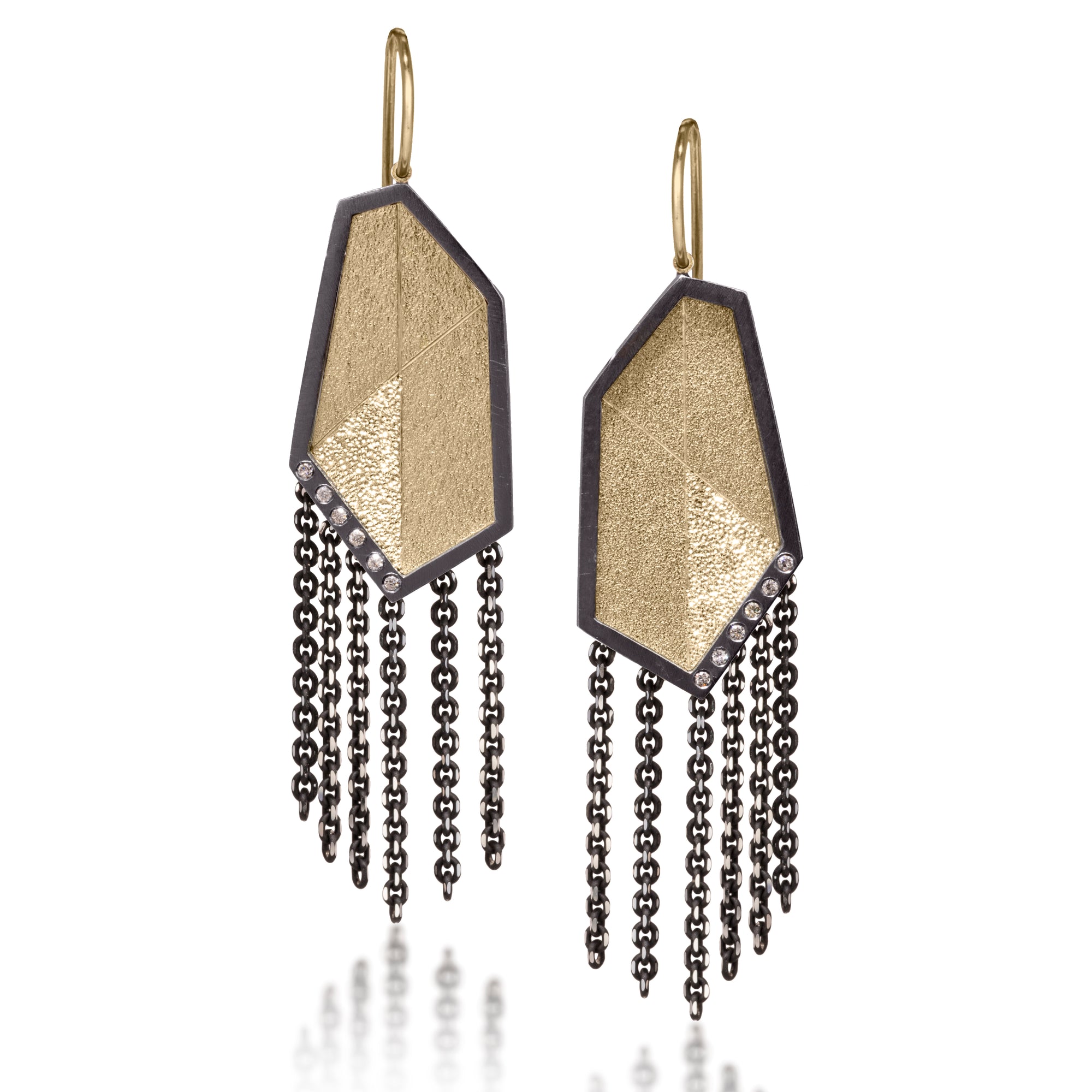 This earring is created with oxidized sterling silver and richly textured 18k bimetal, flush set with ideal cut white diamonds. It features 14k gold posts or 18k gold ear wires. Accent facet glitters with the texture of diamond facets, individually scored and textured. Elongated shape, size medium. Available in post, post fringe, drop or drop fringe styles.  0.0828 tcw
