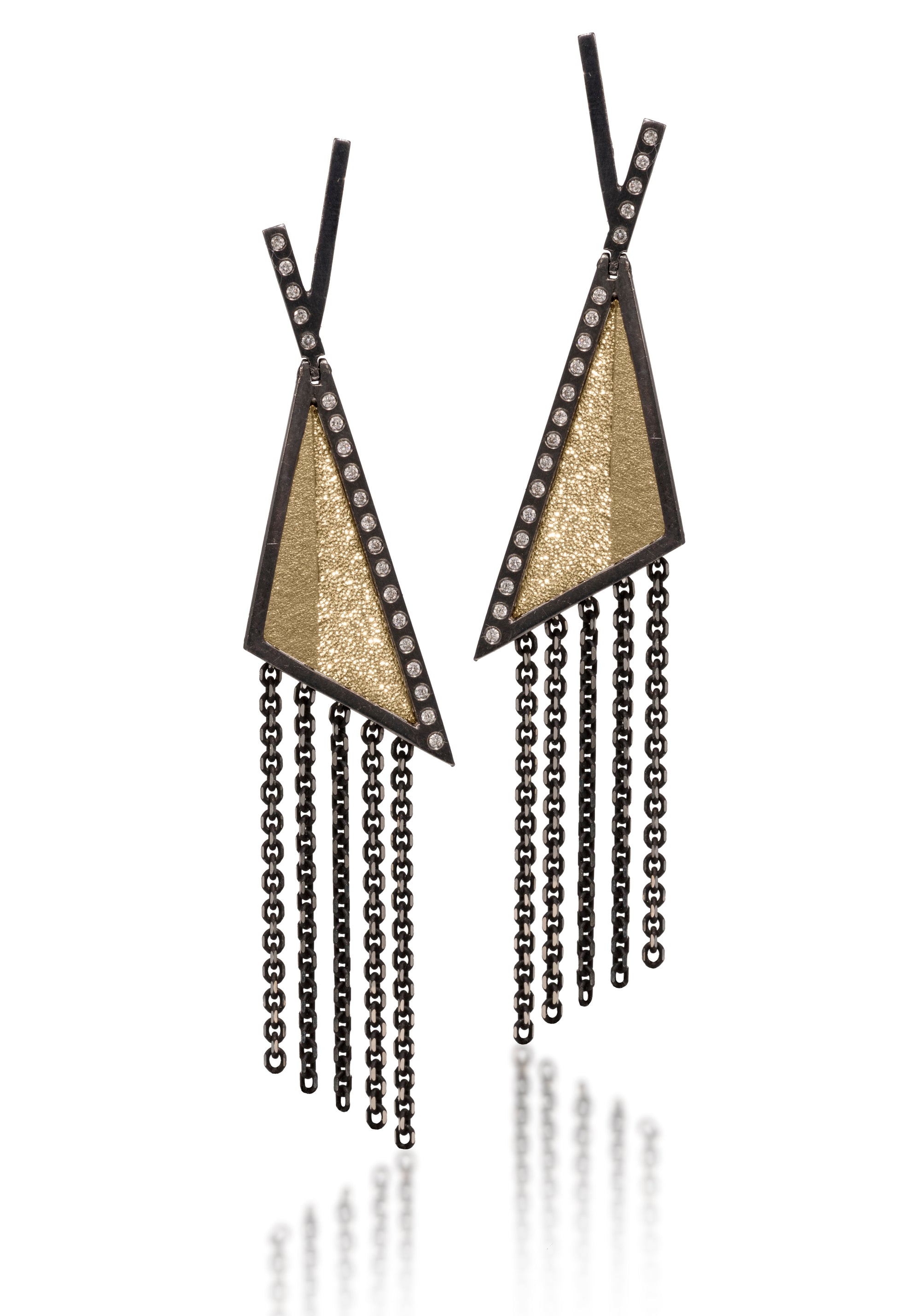 This oxidized sterling silver and richly textured 18k bimetal earring is flush set with ideal cut white diamonds. Hinged top with 14k gold posts. Accent facet glitters with the texture of diamond facets, individually scored and textured. Available in post and fringe styles.  0.276 tcw