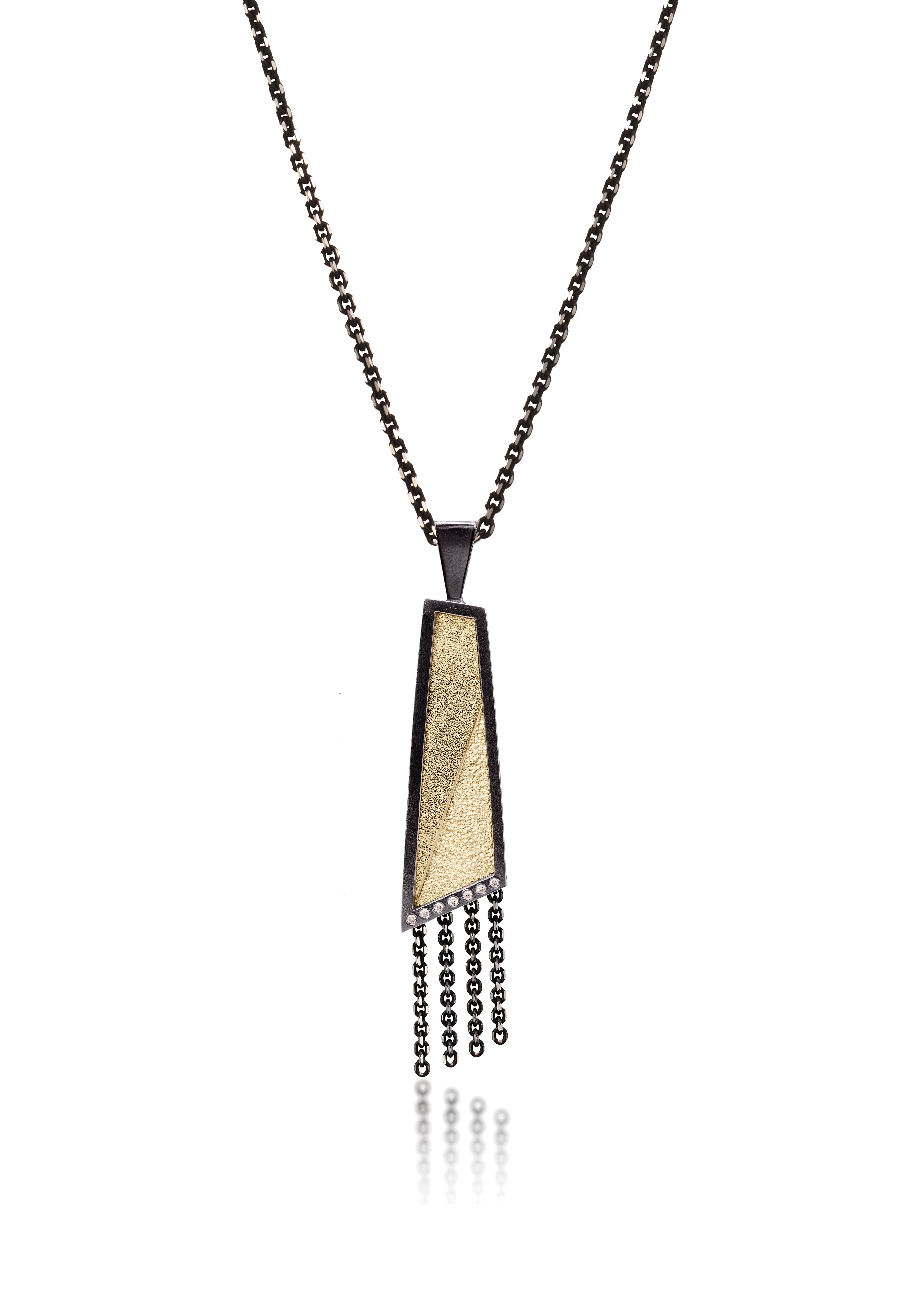 This oxidized sterling silver and richly textured 18k bimetal pendant is flush set with ideal cut white diamonds.  Accent facet glitters with the texture of diamond facets, individually scored and textured.  Elongated shape in medium length, available with or without diamond cut chain fringe. 0.0483 tcw 