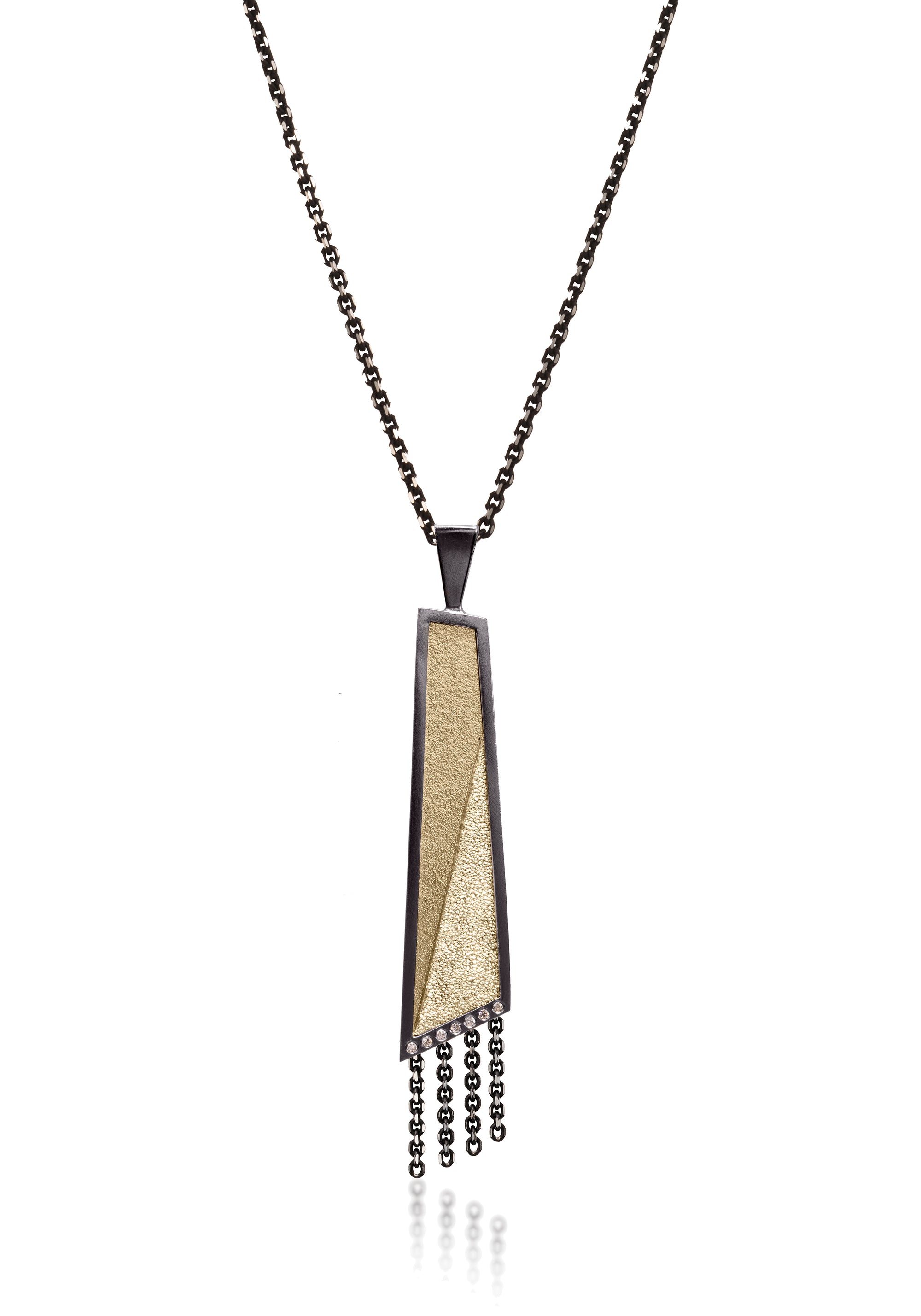 This oxidized sterling silver and richly textured 18k bimetal pendant is flush set with ideal cut white diamonds.  Accent facet glitters with the texture of diamond facets, individually scored and textured.  Elongated shape in longest length, available with or without diamond cut chain fringe. 0.0483 tcw 