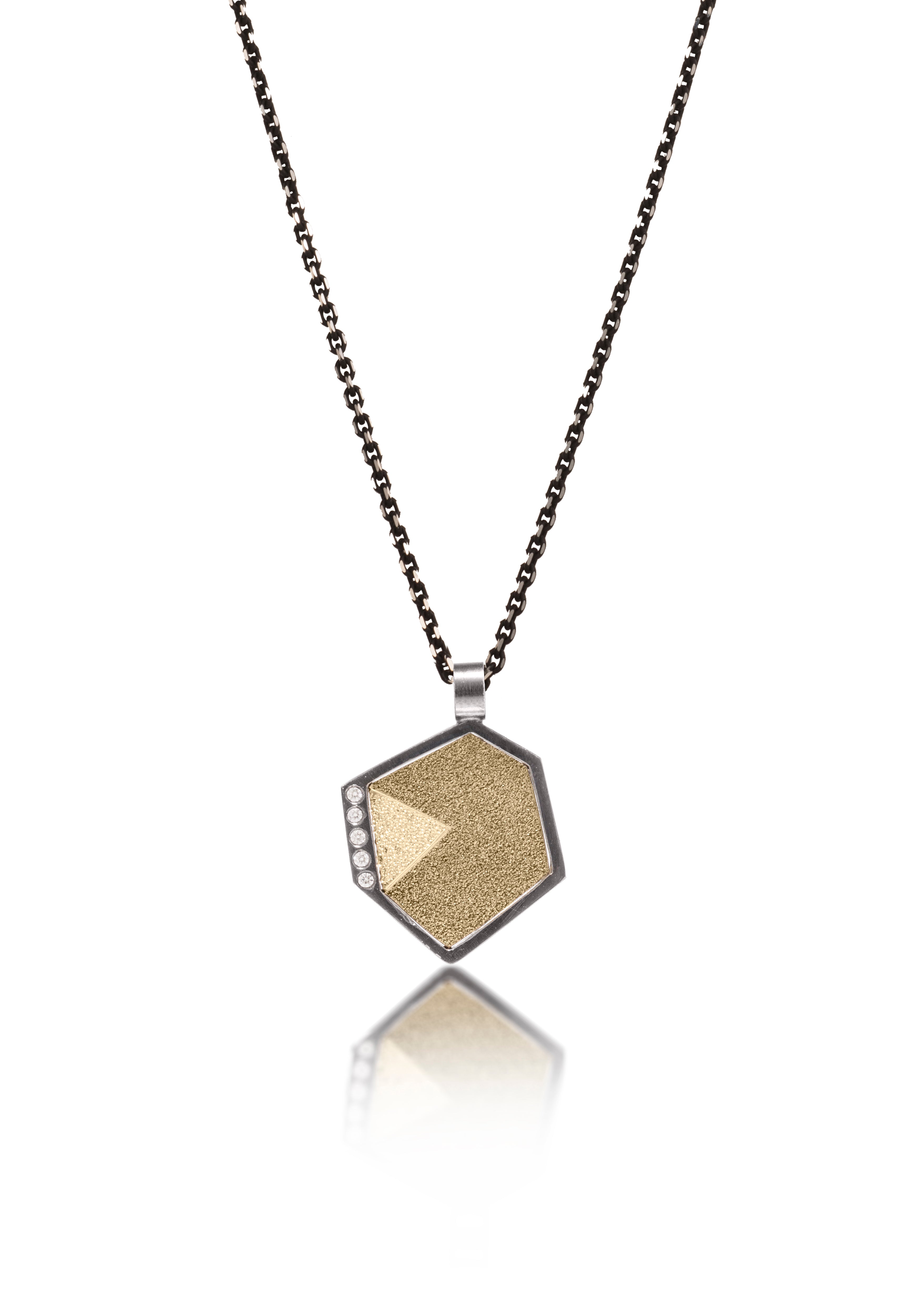 This oxidized sterling silver and richly textured 18k bimetal pendant is flush set with ideal cut white diamonds.  Accent facet glitters with the texture of diamond facets, individually scored and textured. Small size. Available in three oxidized sterling bail options, ID 3.25mm (pictured), fixed elongated, or elongated enhancer bail.