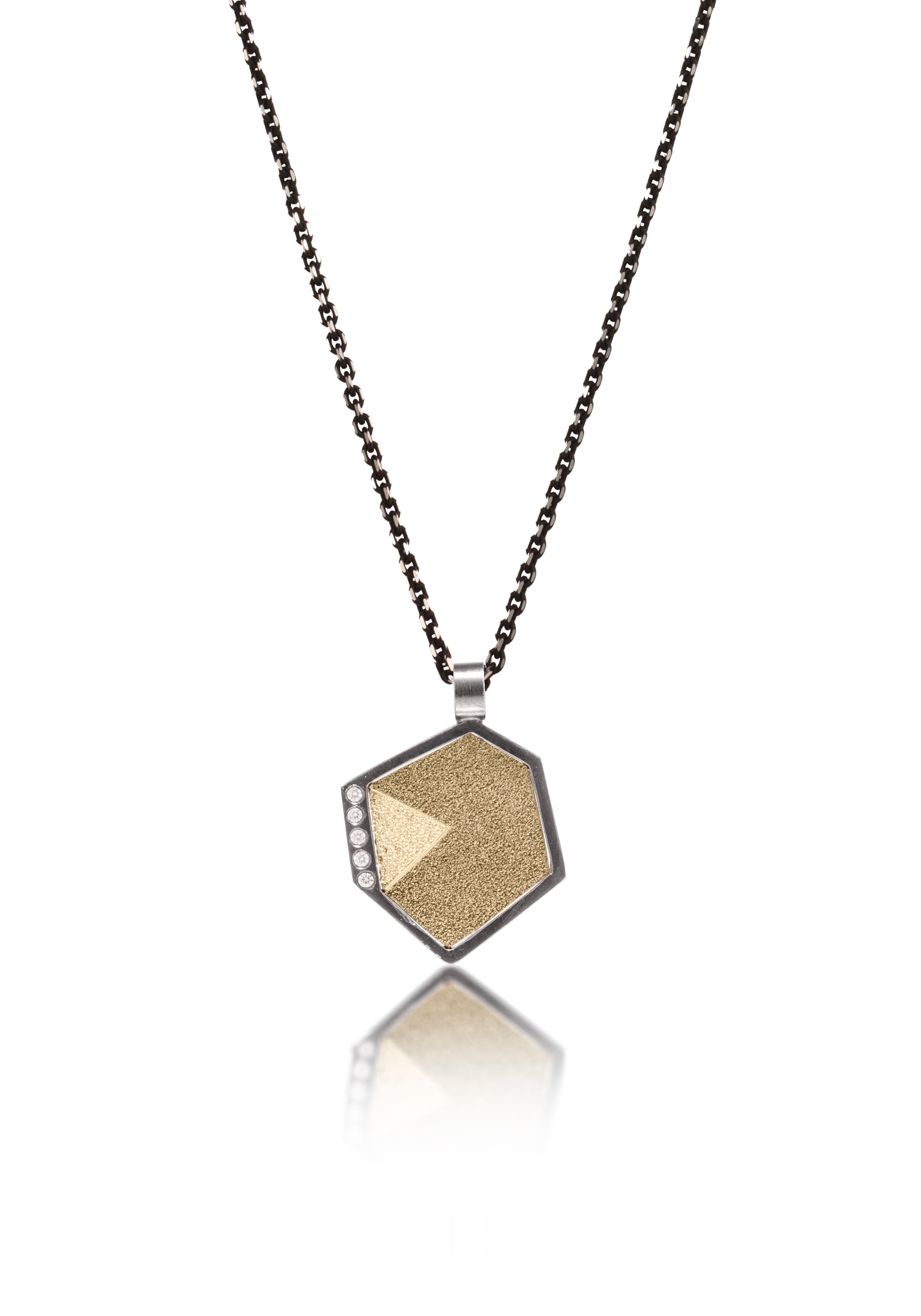 This oxidized sterling silver and richly textured 18k bimetal pendant is flush set with ideal cut white diamonds.  Accent facet glitters with the texture of diamond facets, individually scored and textured. Small size. Available in three oxidized sterling bail options, ID 3.25mm (pictured), fixed elongated, or elongated enhancer bail.