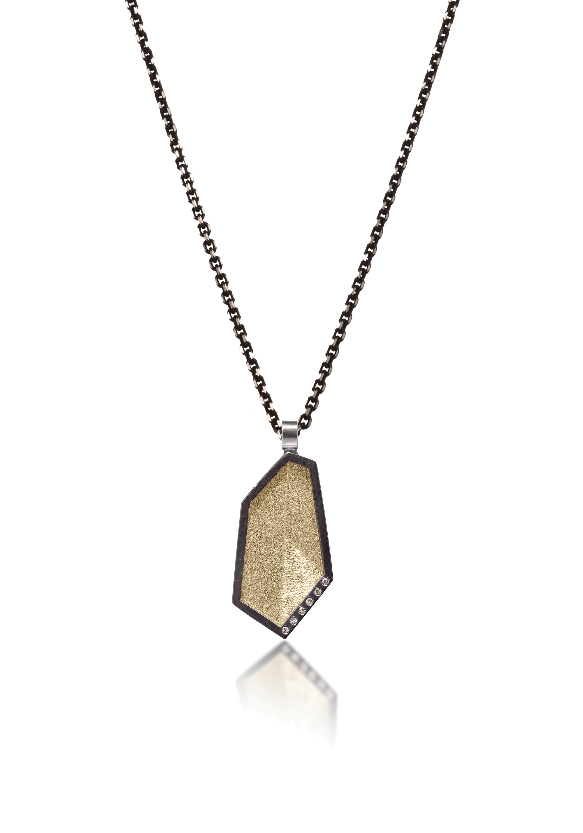This oxidized sterling silver and richly textured 18k bimetal pendant is flush set with ideal cut white diamonds. Oxidized sterling bail ID 3.25mm. Accent facet glitters with the texture of diamond facets, individually scored and textured. Elongated shape in size small.  0.0414 tcw