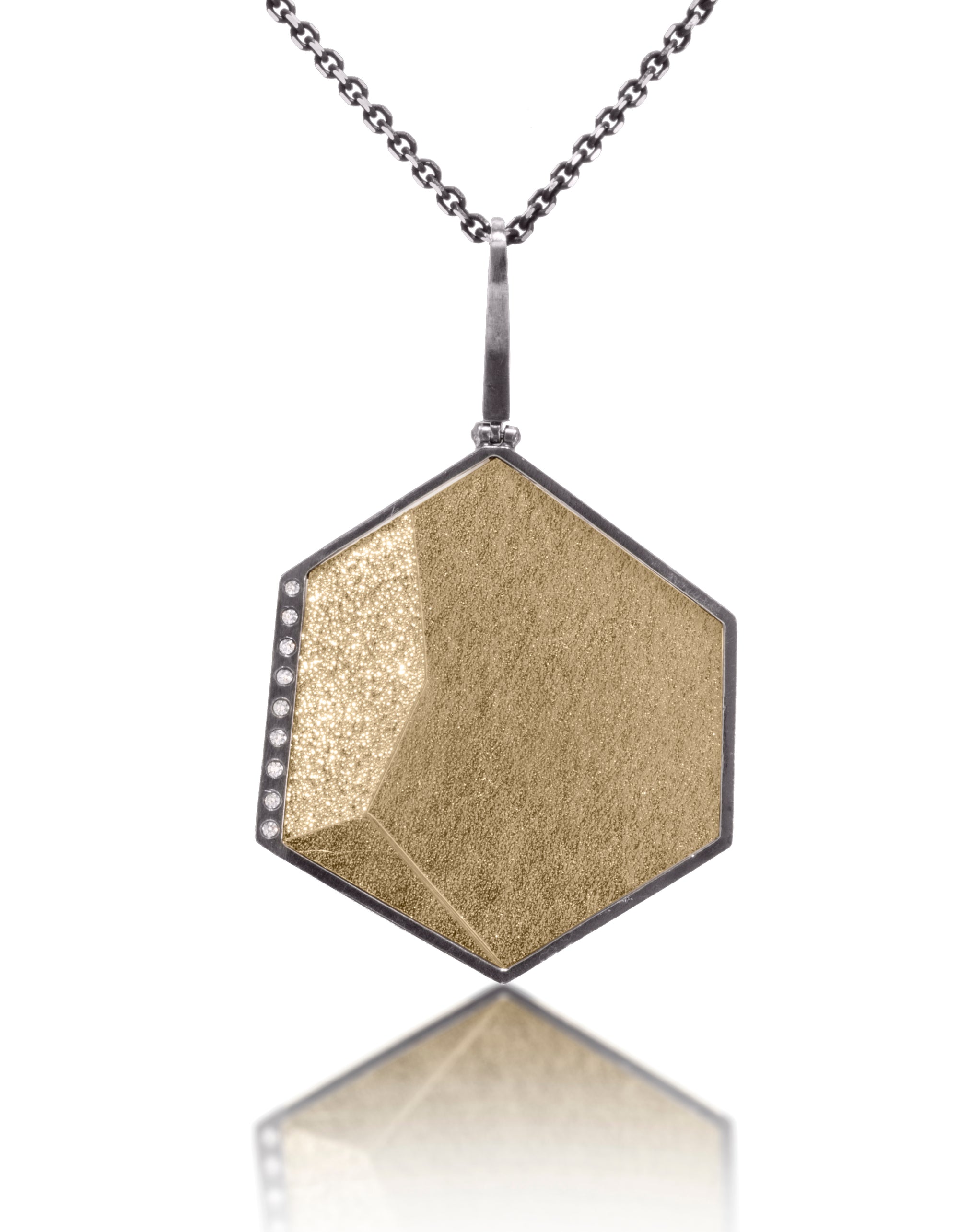 This oxidized sterling silver and richly textured 18k bimetal pendant is flush set with ideal cut white diamonds.  Accent facet glitters with the texture of diamond facets, individually scored and textured. Size large.  Available in oxidized silver bail, 3.25mm, fixed elongated and elongated enhancer bail styles.  0.0621 tcw