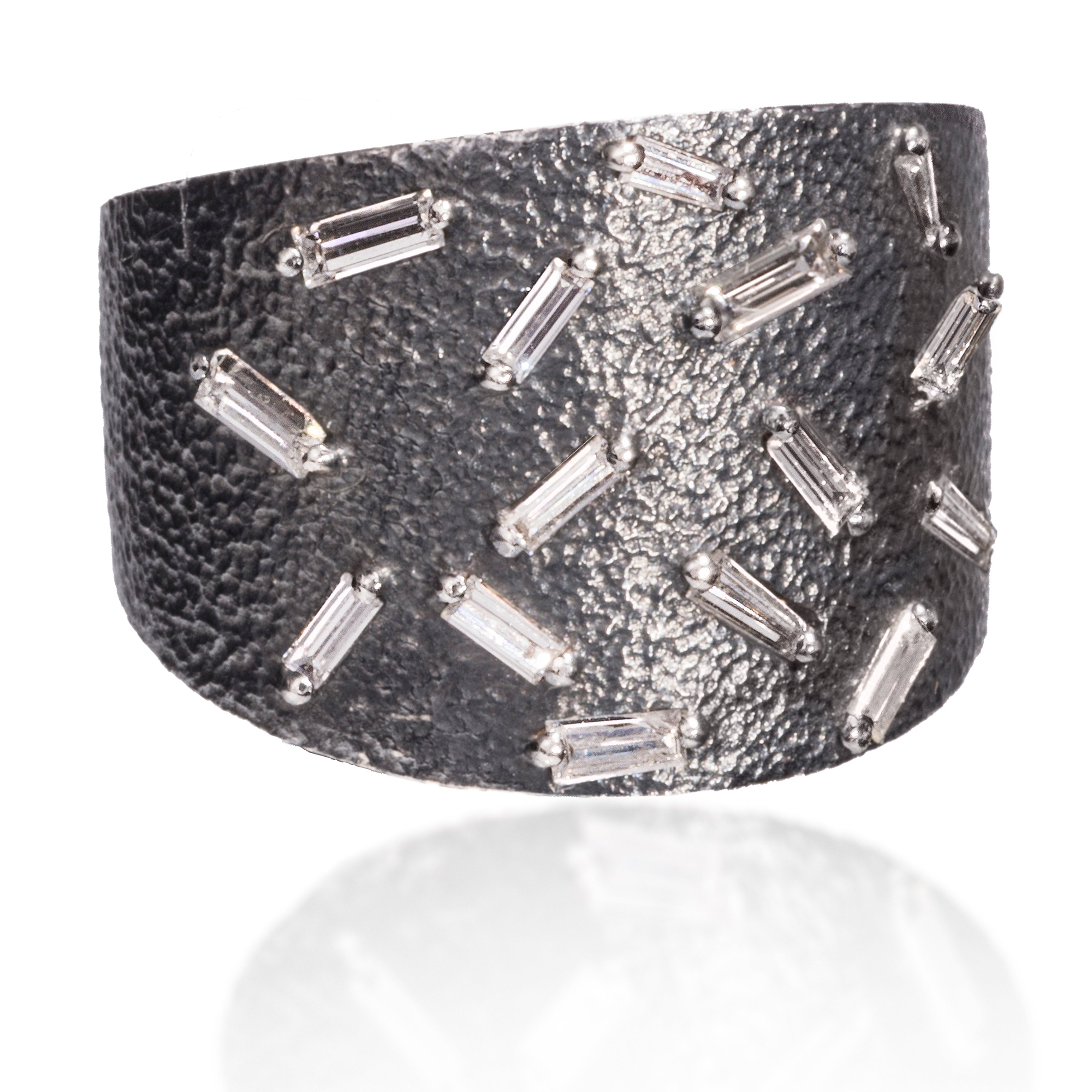 This larger cigar band style ring in oxidized sterling features a glimmering 15 white diamond baguettes. The richly textured surface in combination with the diamonds comes to life with the slightest light.  0.479 tcw.