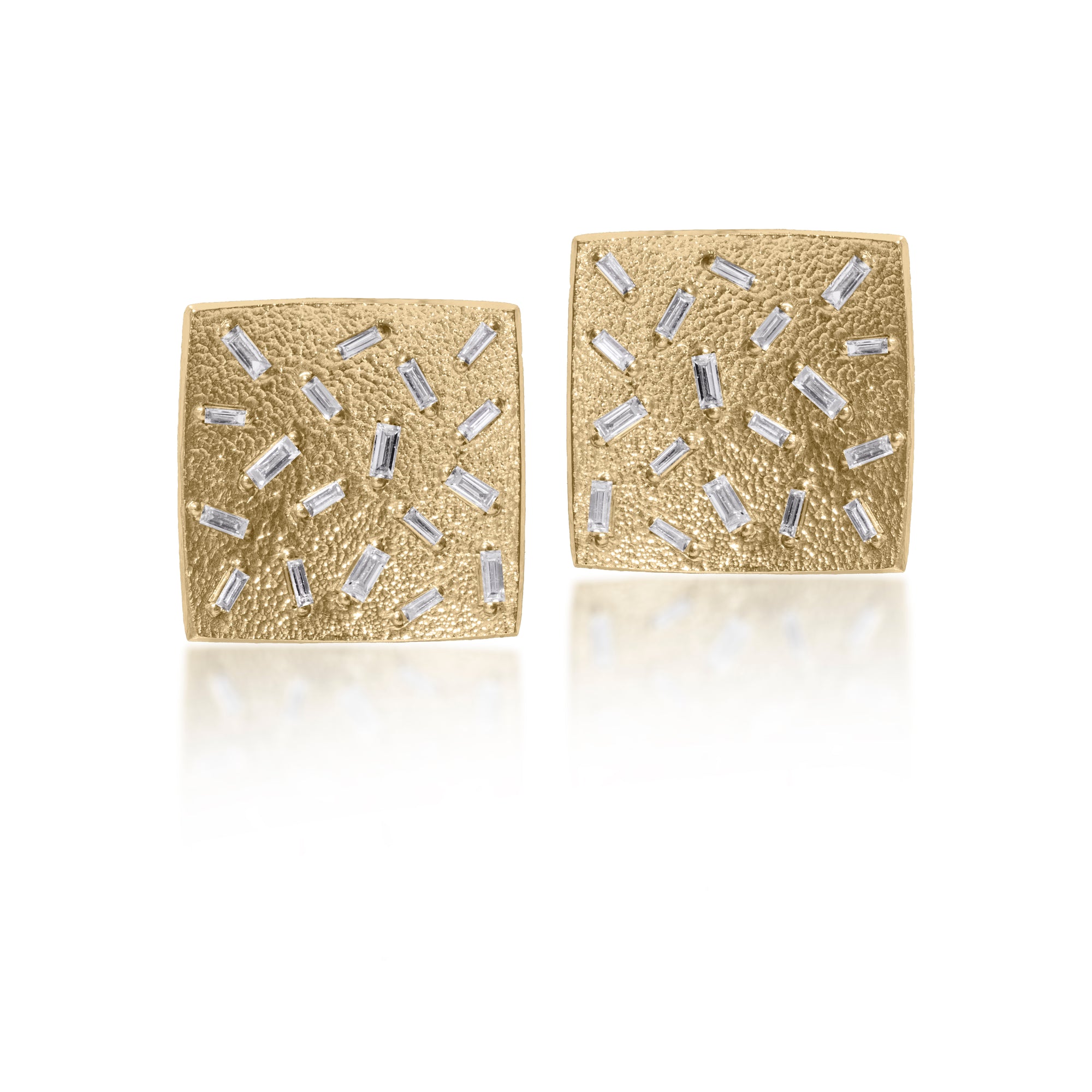This simple but dramatic post earring is perfect for everyday or a fabulous night out.  Offered in three richly textured color ways, oxidized sterling, 18k gold, palladium.  Each earring set with 18 white diamond baguettes.   0.972 tcw.