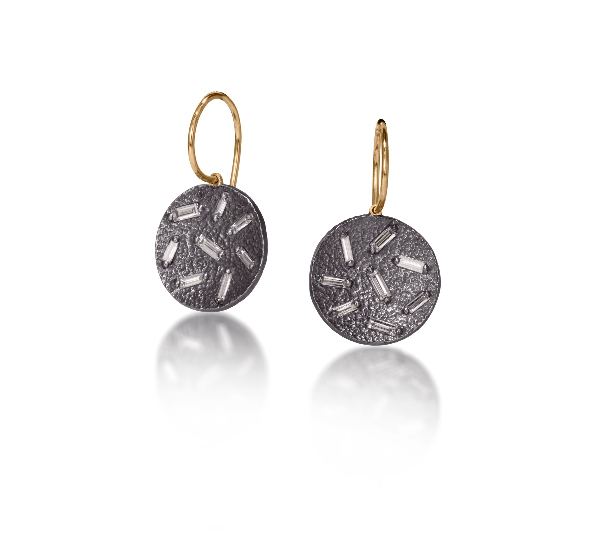 This is a simple, elegant, perfect everyday earring.  Offered in three richly textured color ways, oxidized sterling with 18k ear wire, 18k gold, palladium.  Each earring set with 8 white diamond baguettes. 0.454 tcw.