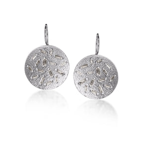 This simple but dramatic drop earring is perfect for everyday.  Offered in three richly textured color ways, oxidized sterling, 18k gold, palladium.  Each earring set with 16 white diamond baguettes. 0.87 tcw.