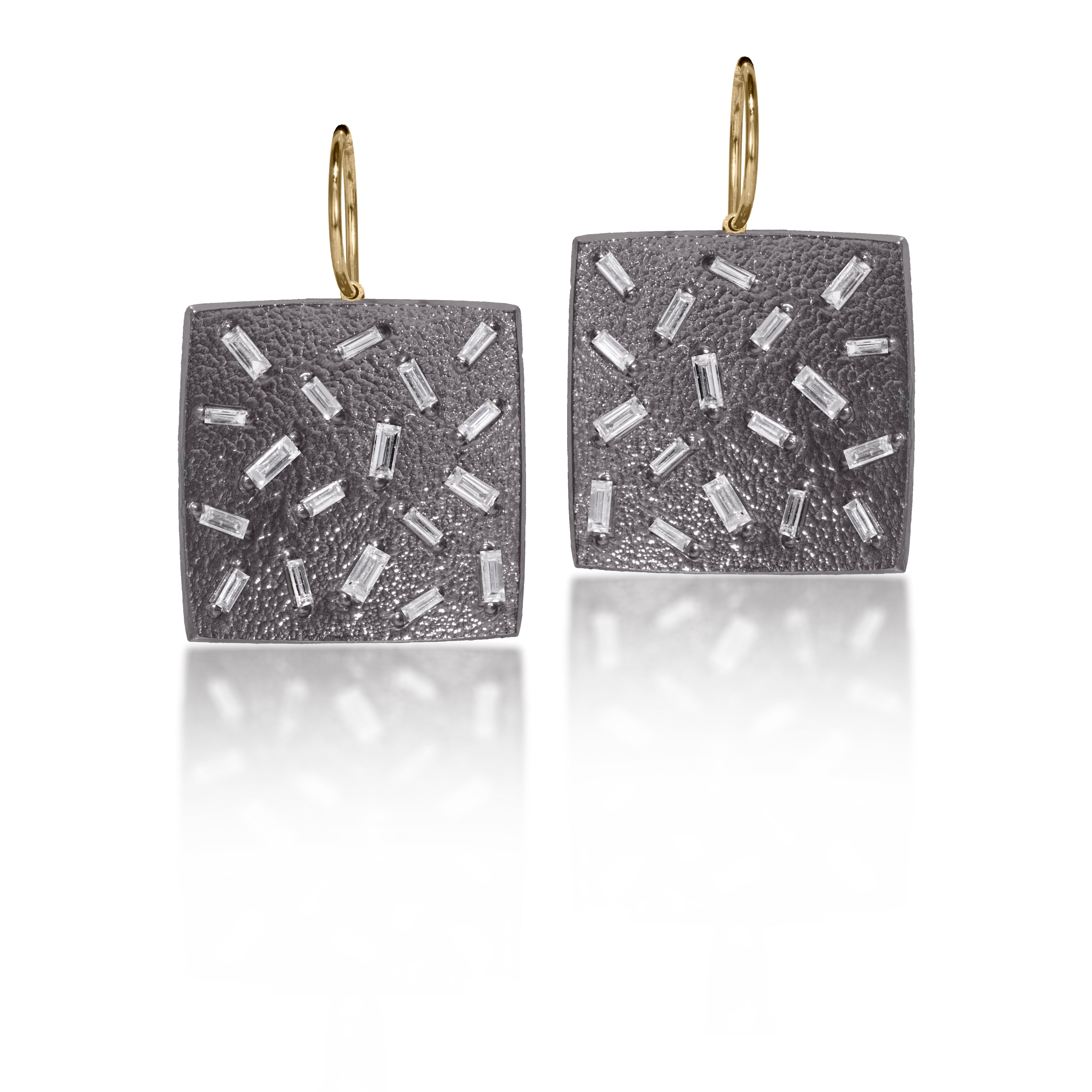 This medium size, simple but dramatic post earring is perfect for everyday or a fabulous night out.  Offered in three richly textured color ways, oxidized sterling, 18k gold, palladium.  Each earring set with 18 white diamond baguettes.  0.972 tcw.