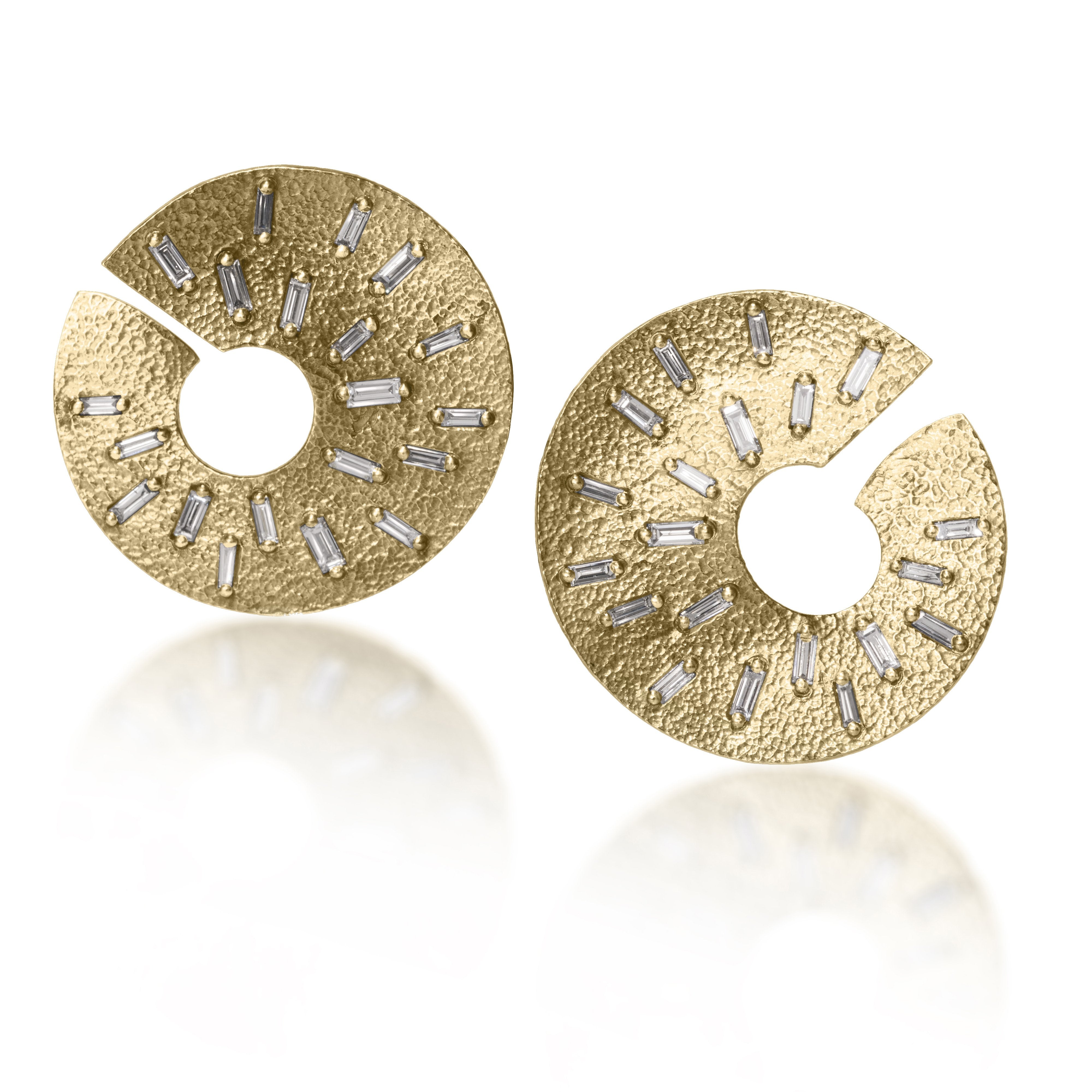 The smaller of two radiant styled earrings, each set with 21 white diamond baguettes. Richly textured and designed to three dimensionally wrap around from the front to behind the ear.  It is available in three color ways, oxidized silver, 18k gold and palladium.  1.176 tcw.