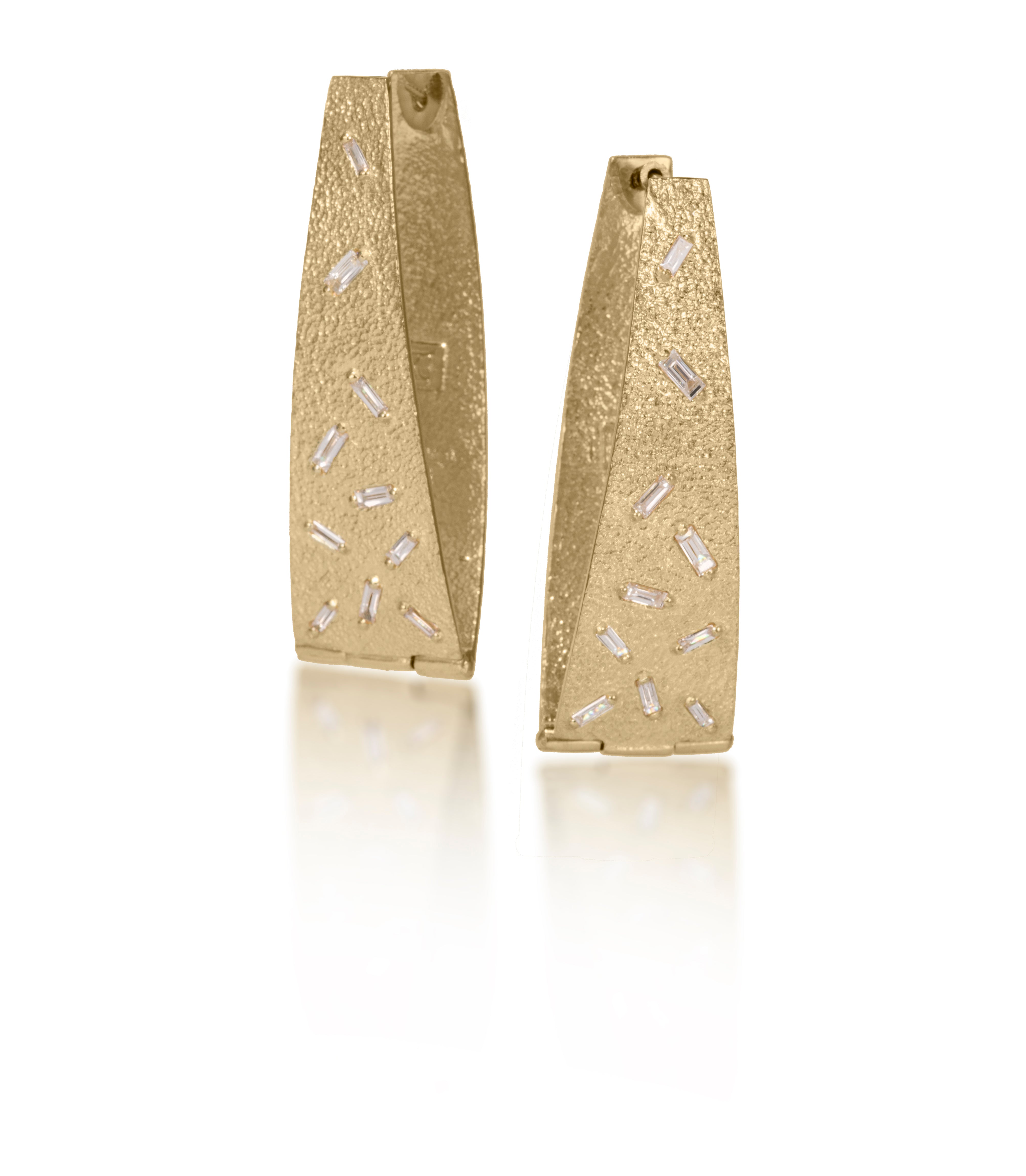 These long, elegant flare, huggie style earring are each set with 10 white diamond baguettes. Richly textured, it is available in three color ways, oxidized silver, 18k gold and palladium.   0.546 tcw.