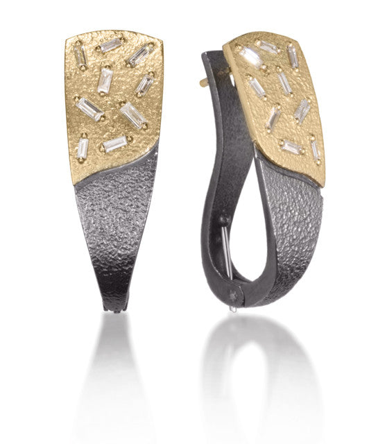Both beautiful and comfortable, this lever style earring in 18k gold and oxidized sterling are each set with 9 white diamond baguettes. Richly textured metal combined with diamond facets shimmers in the light. It features a spring hinged lever back for simplicity and wearability. 0.575 tcw.