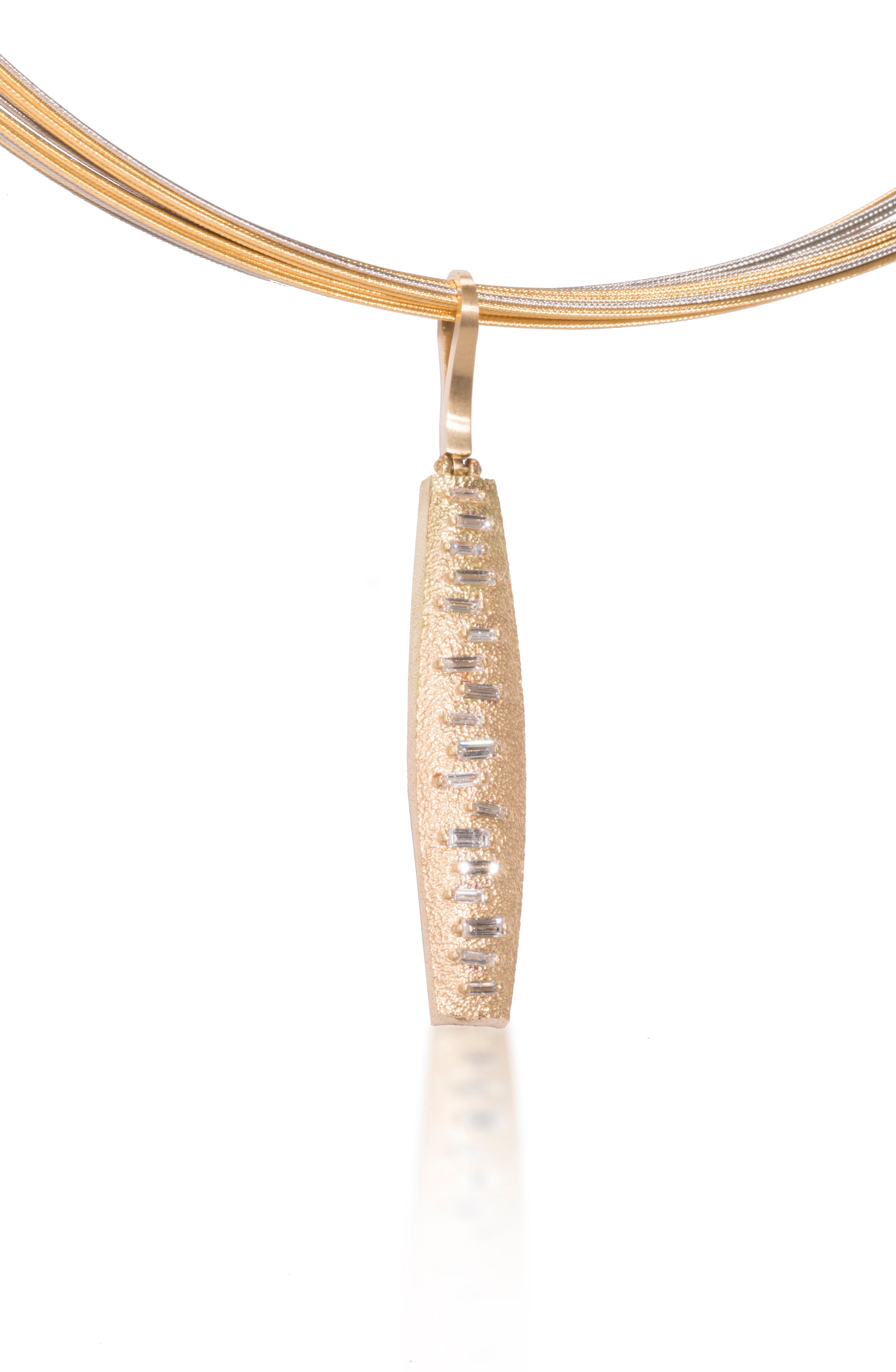 This hinged pendant features a graceful, curved and tapered form. The playful irregularity of the baguette angles catch the light in dynamic ways when worn. Design is offered in four richly textured color ways, oxidized sterling, oxidized sterling/18k gold, 18k gold and palladium. 0.555 tcw.