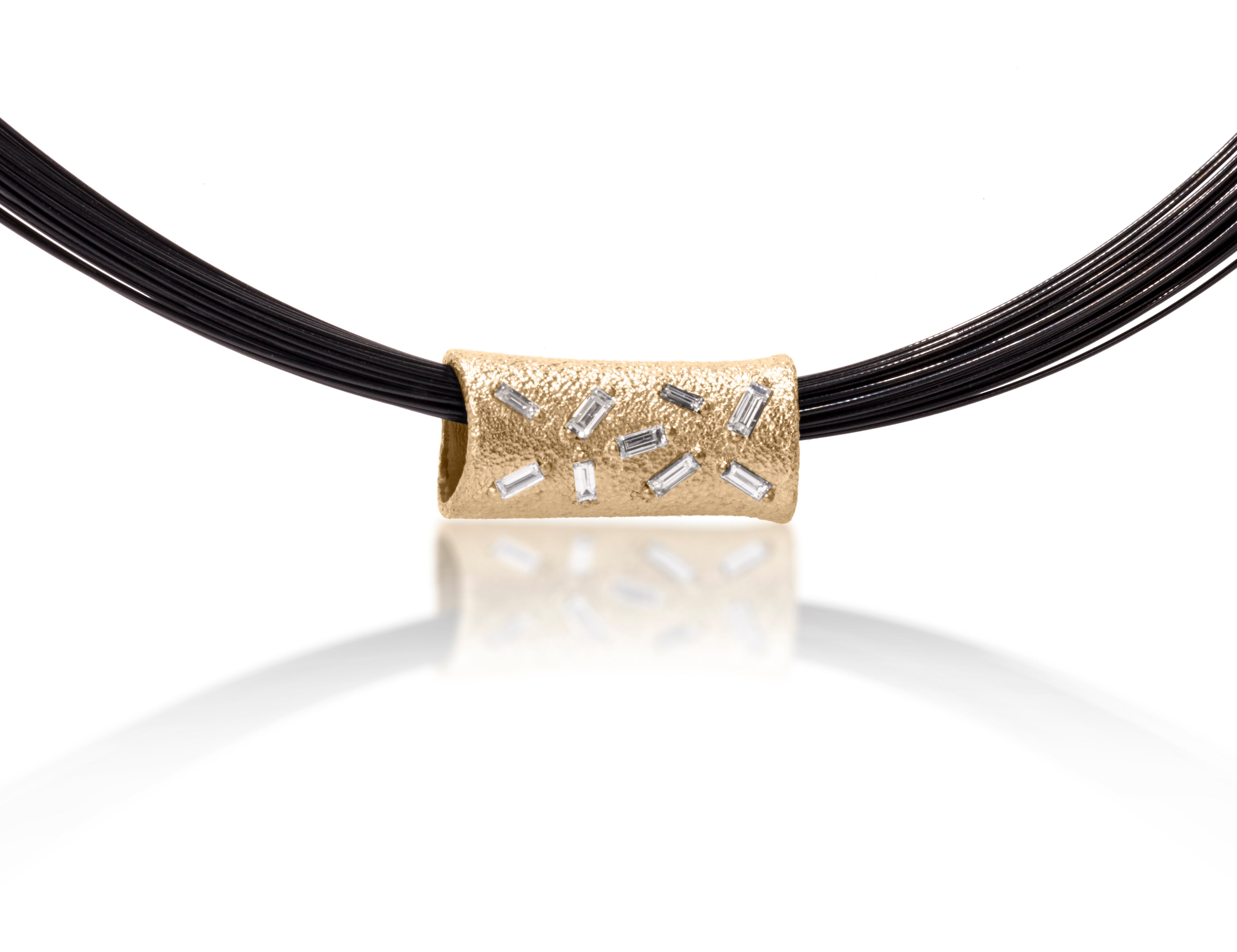 Richly textured and simply engineered to hang with diamonds forward, this piece is available in three color ways, oxidized silver, 18k gold and palladium.  This elegant pendant is set with 9 white diamond baguettes. 0.287 tcw.